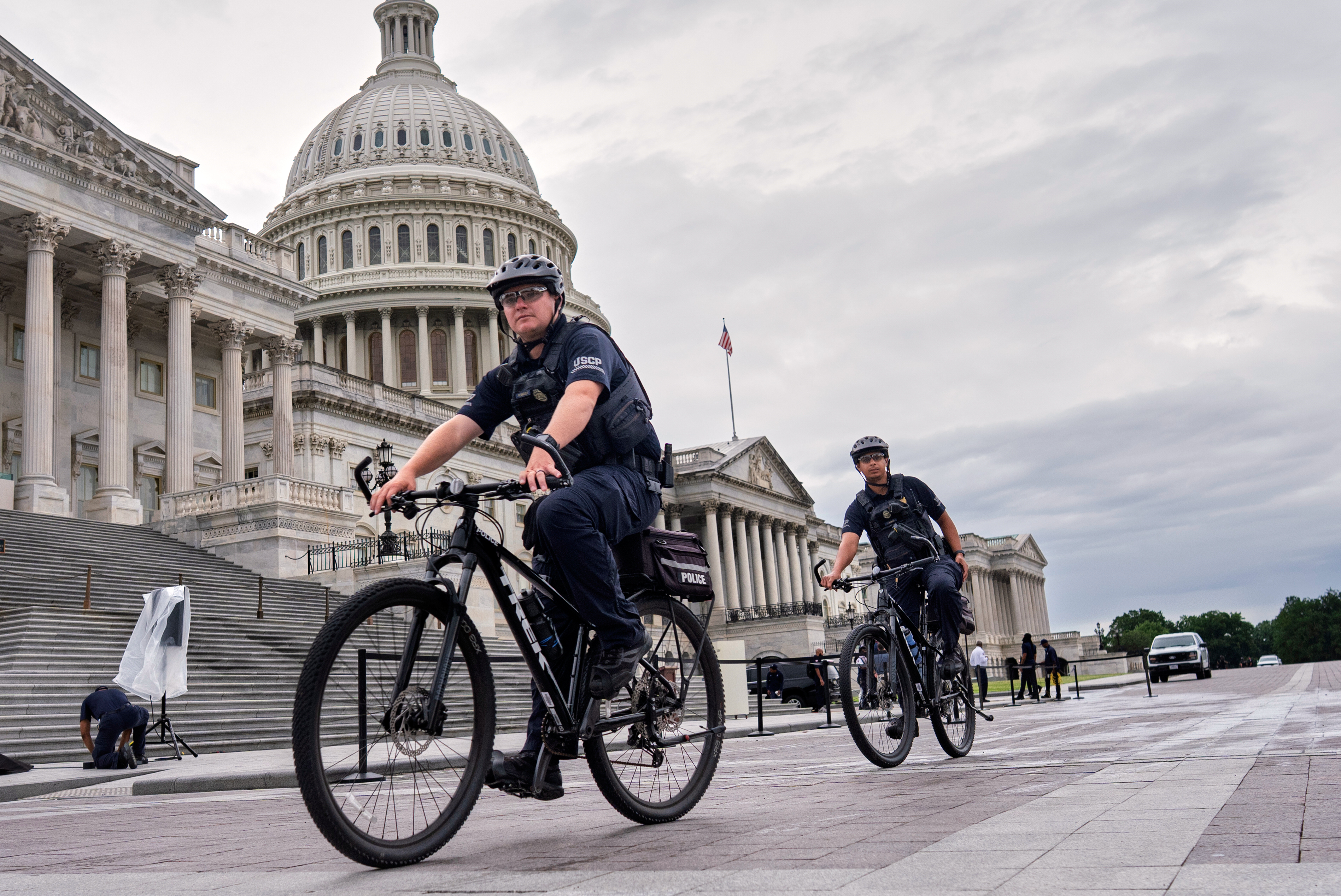 U.S. Capitol Police patrol the plaza as House Republicans work inside to pass President Donald Trump's signature bill of tax breaks and spending cuts by a self-imposed Fourth of July deadline, at the Capitol in Washington, Wednesday, July 2, 2025. (AP Photo/J. Scott Applewhite)