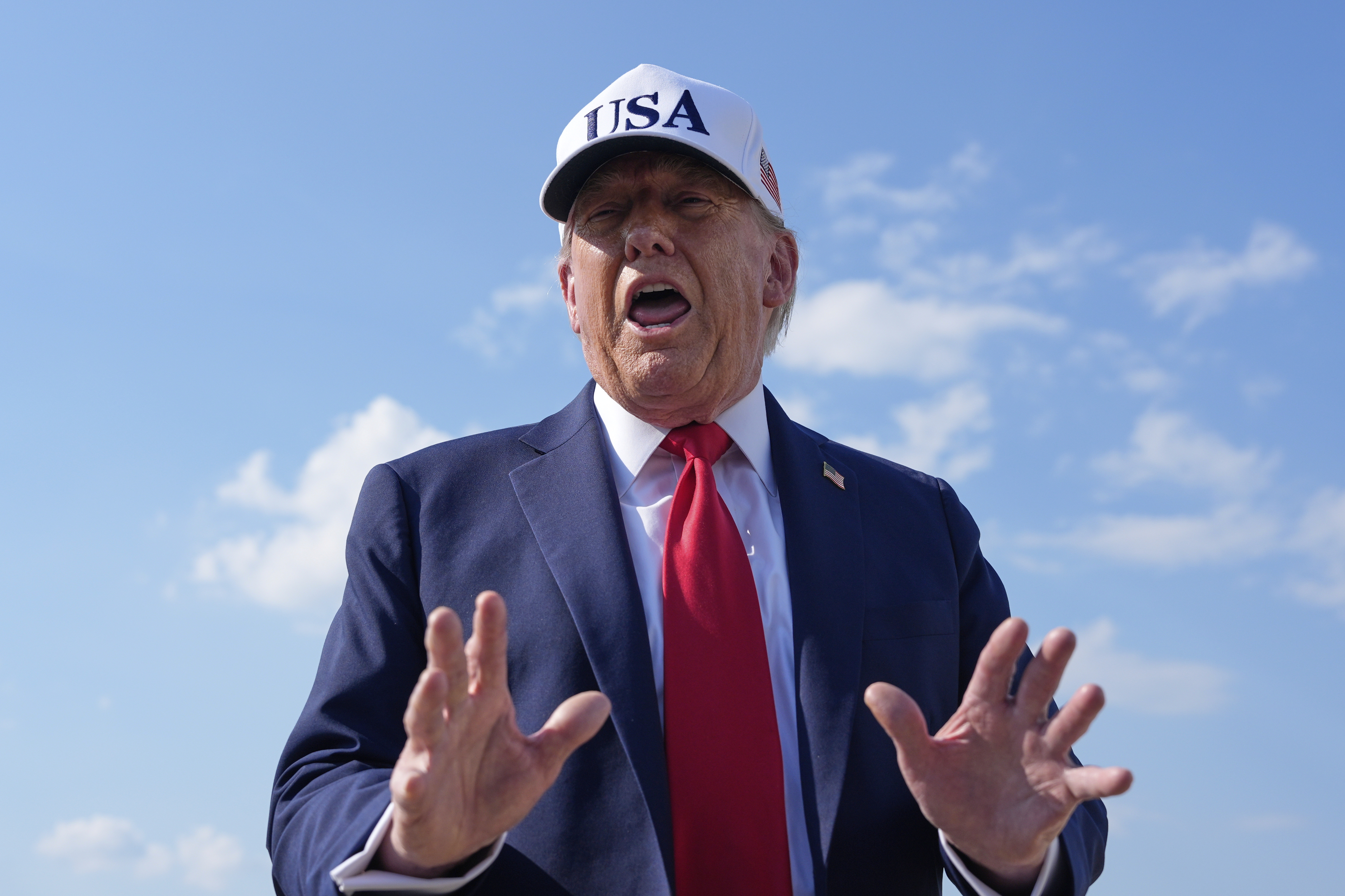 President Donald Trump talks to reporters before boarding Air Force One, Thursday, July 3, 2025, at Joint Base Andrews, Md. (AP Photo/Alex Brandon)
