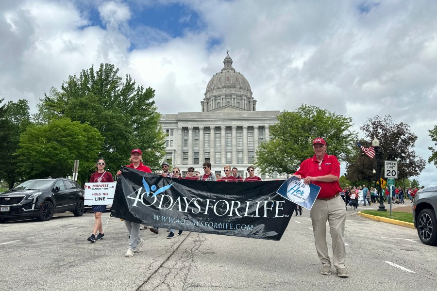 FILE - Participants in the Midwest March for Life walk through the streets of Jefferson City, Mo., in front of the state Capitol on May 1, 2025. (AP Photo/David A. Lieb, File)