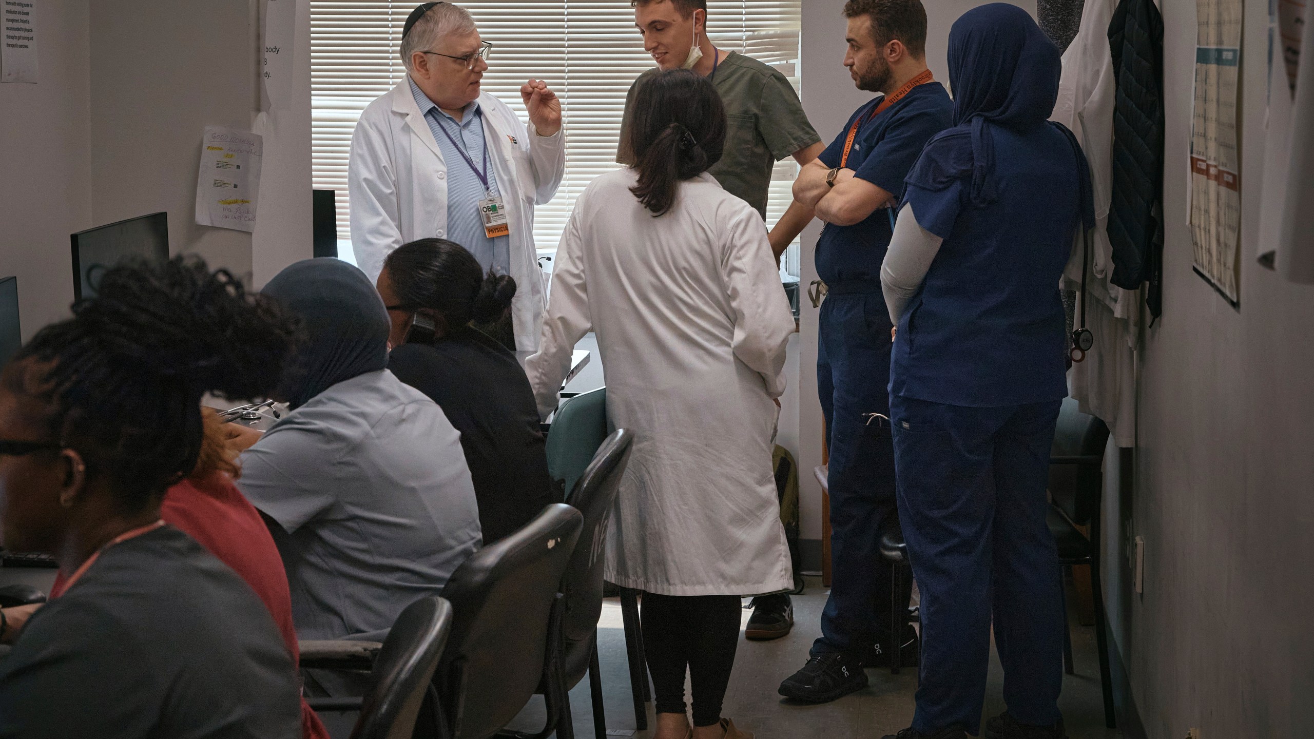 A group of resident doctors talks with a senior doctor inside Brookdale University Hospital and Medical Center on Tuesday, July 1, 2025, in the Brooklyn borough of New York. (AP Photo/Andres Kudacki)