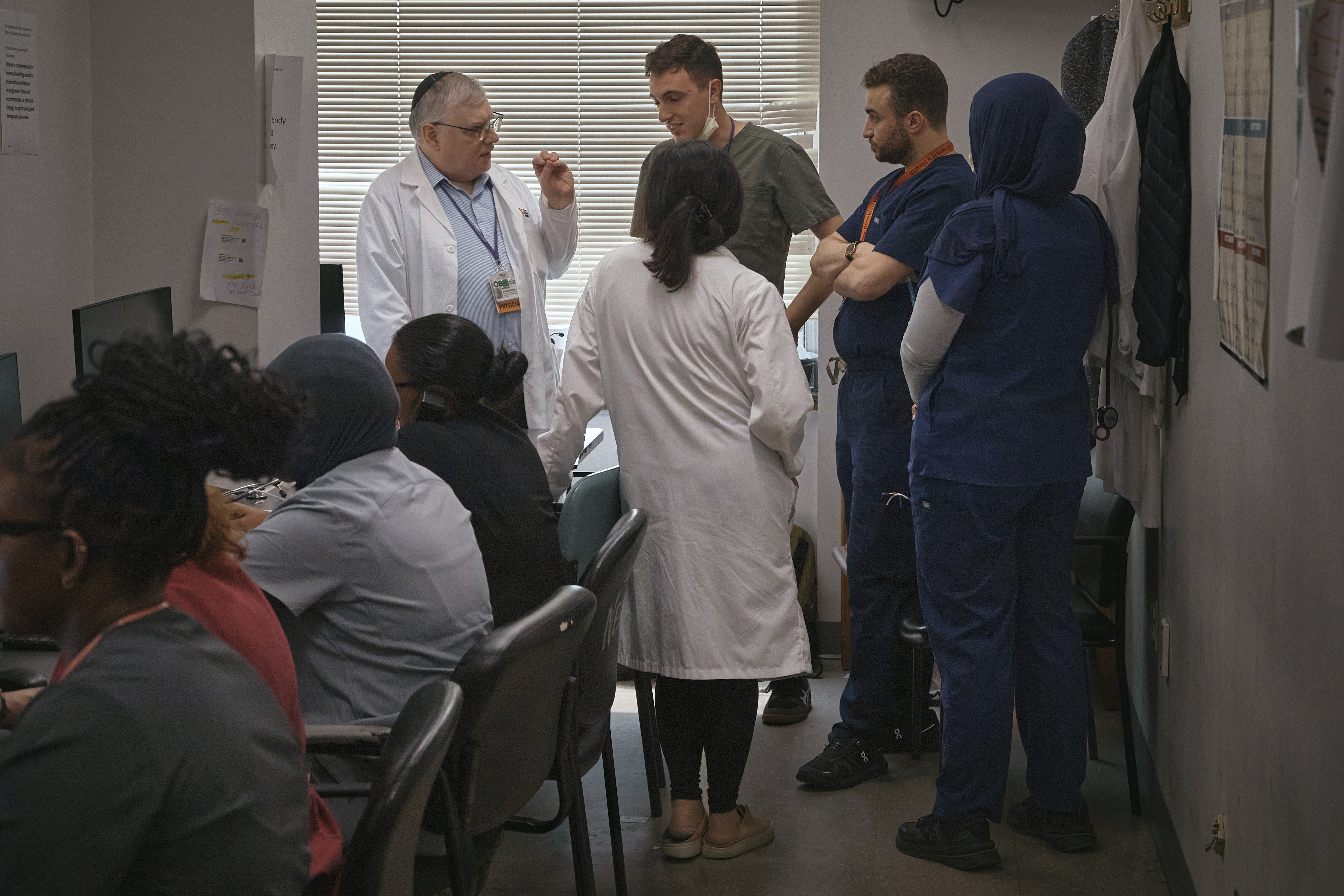 A group of resident doctors talks with a senior doctor inside Brookdale University Hospital and Medical Center on Tuesday, July 1, 2025, in the Brooklyn borough of New York. (AP Photo/Andres Kudacki)