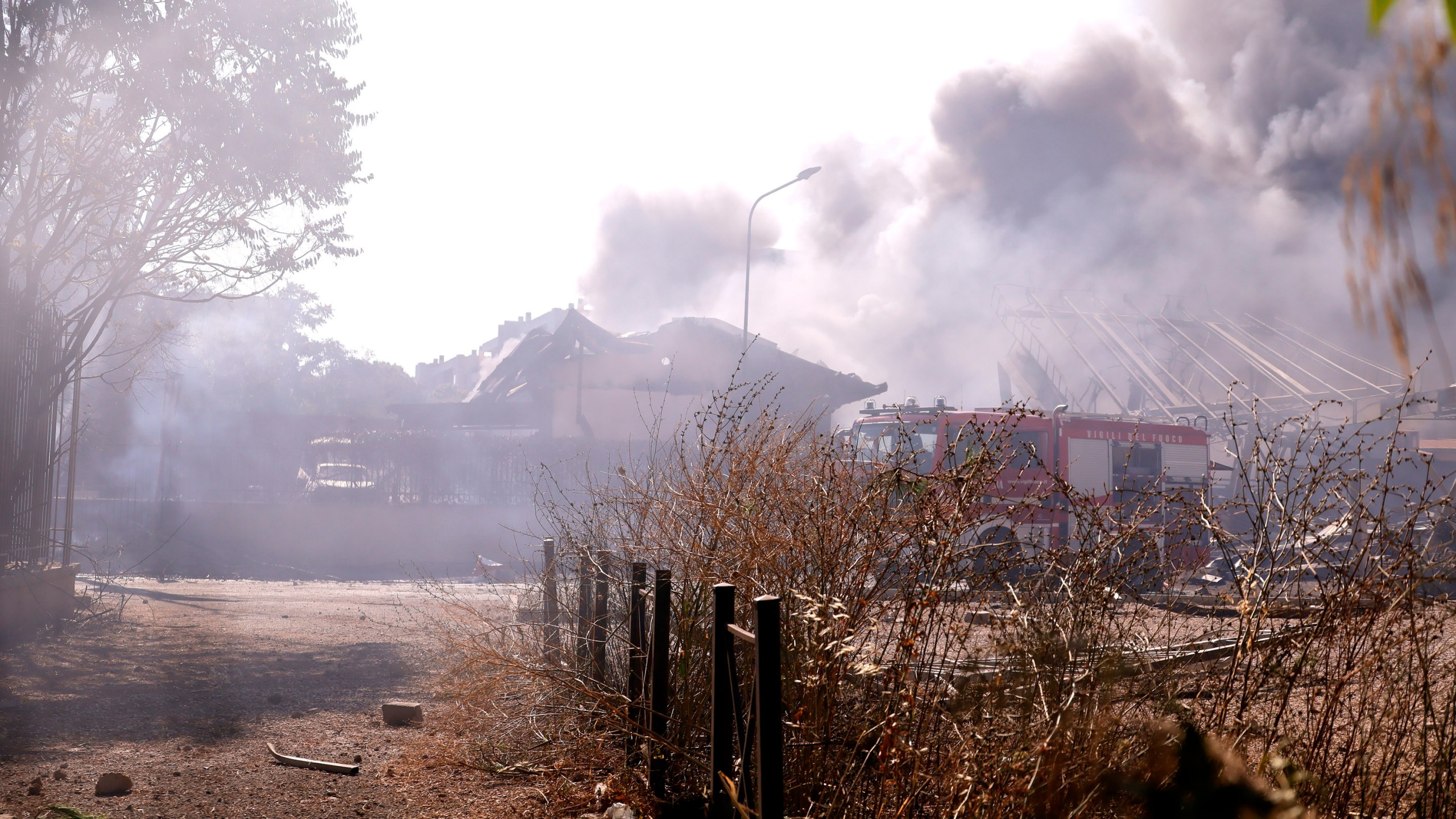 Firefighters work as smoke rises after a gas station exploded on the outskirts of Rome, Friday, July 4, 2025. (Cecilia Fabiano/LaPresse via AP)