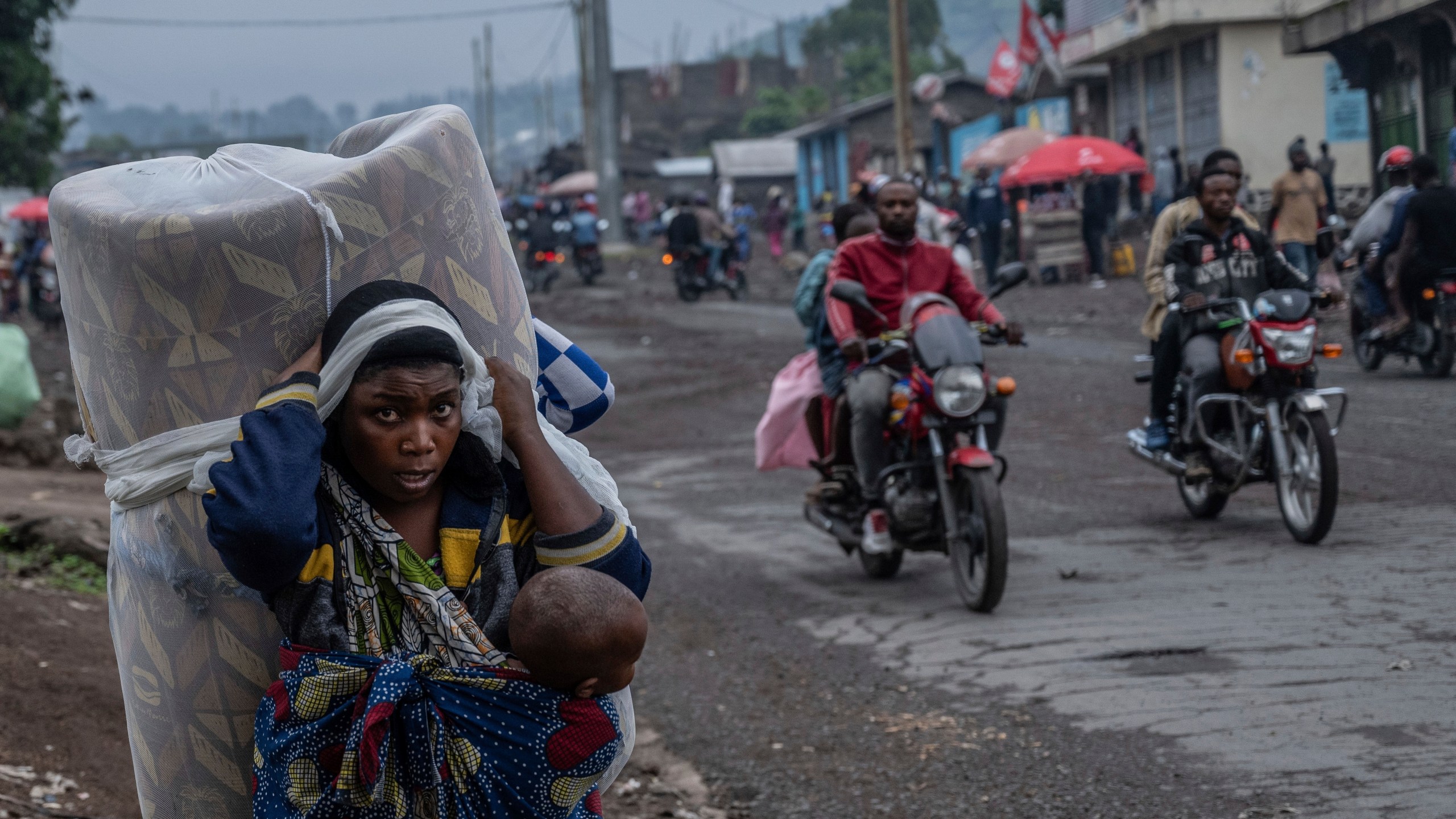 FILE - People displaced by the fighting with M23 rebels make their way to the center of Goma, Democratic Republic of the Congo, Sunday, Jan. 26, 2025. (AP Photo/Moses Sawasawa, File)