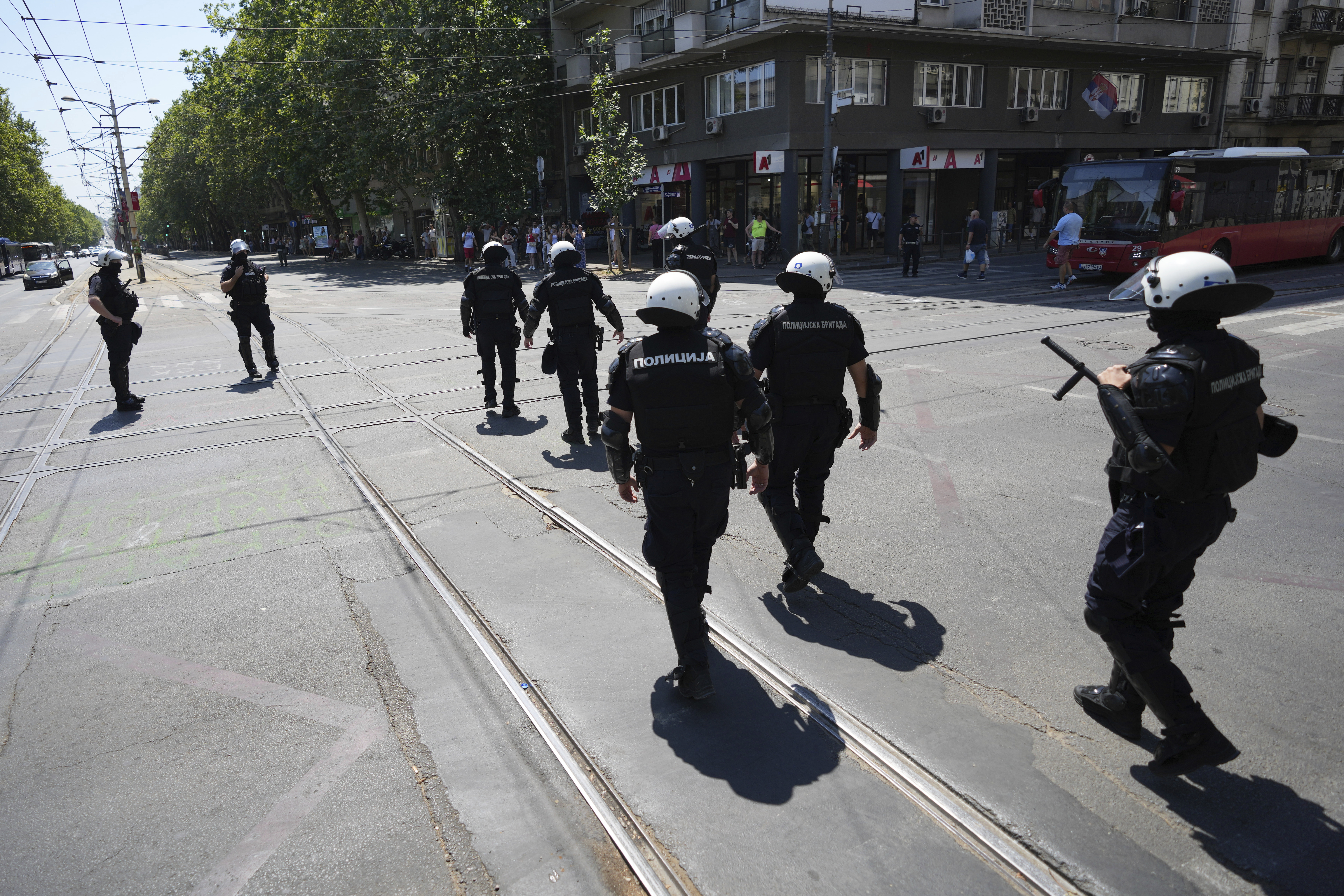Serbian riot police officers guard intersection after remove street blockades that was set up as part of a protest after a massive rally demanding an early parliamentary election in Belgrade, Serbia, Friday, July 4, 2025. (AP Photo/Darko Vojinovic)