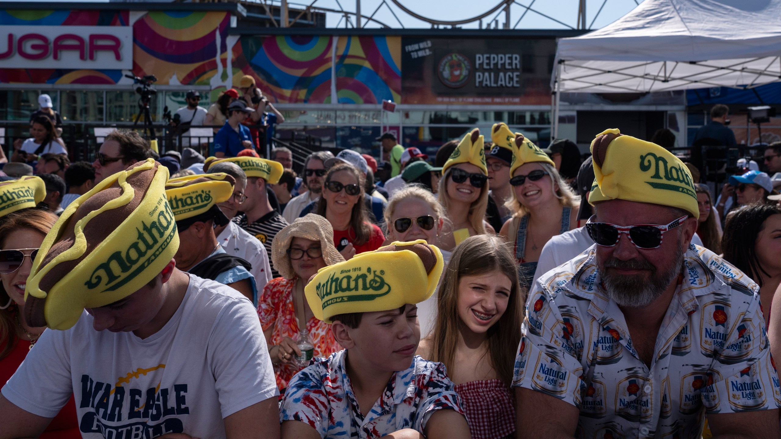 People wait for the 2025 Nathan's Famous Fourth of July hot dog eating contest in the Coney Island section of the Brooklyn borough of New York, Thursday, July 4, 2025. (AP Photo/Yuki Iwamura)