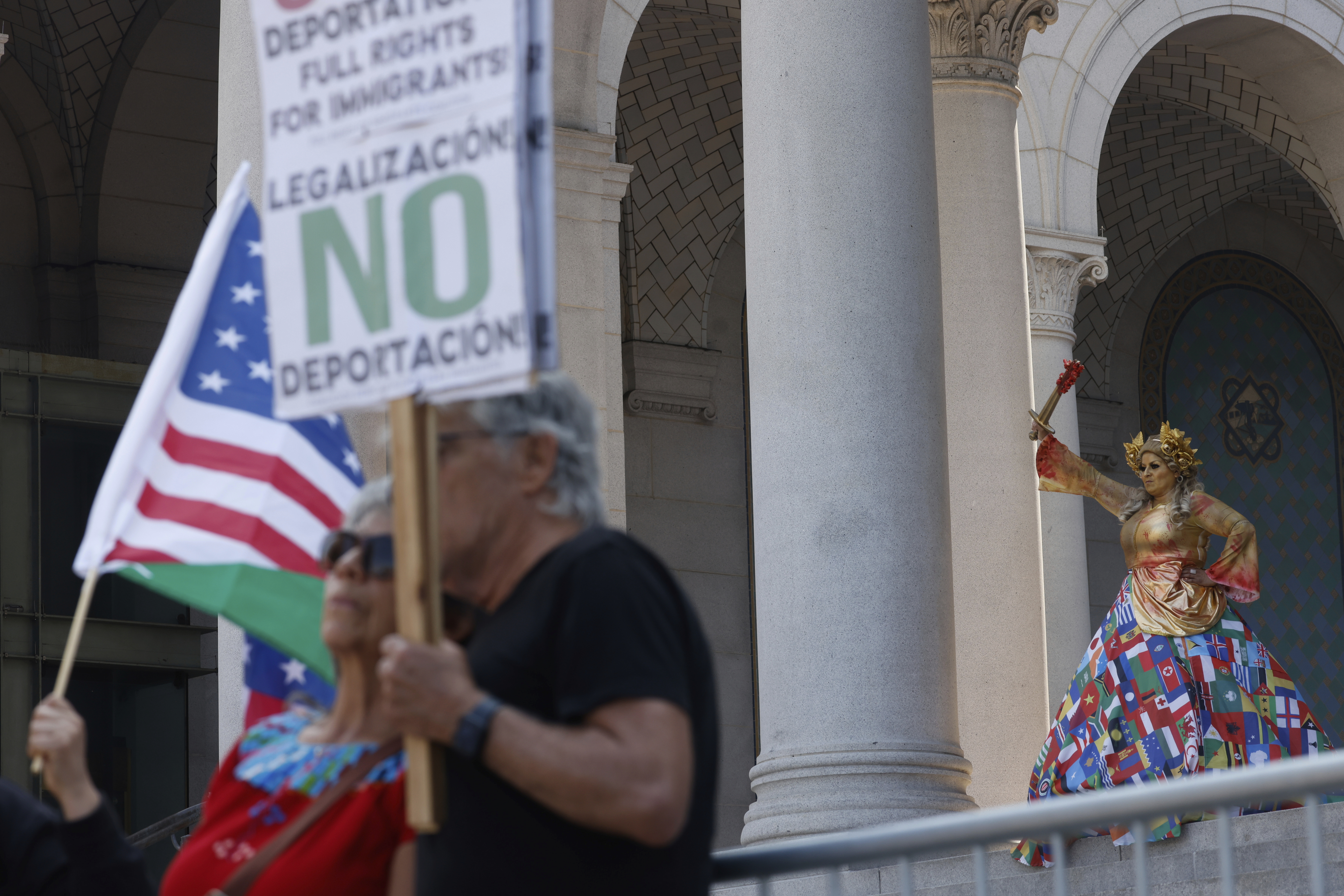 Demonstrators take part in a protest against President Donald Trump's policies on Friday, July 4, 2025 in Los Angeles. (AP Photo/Jill Connelly)