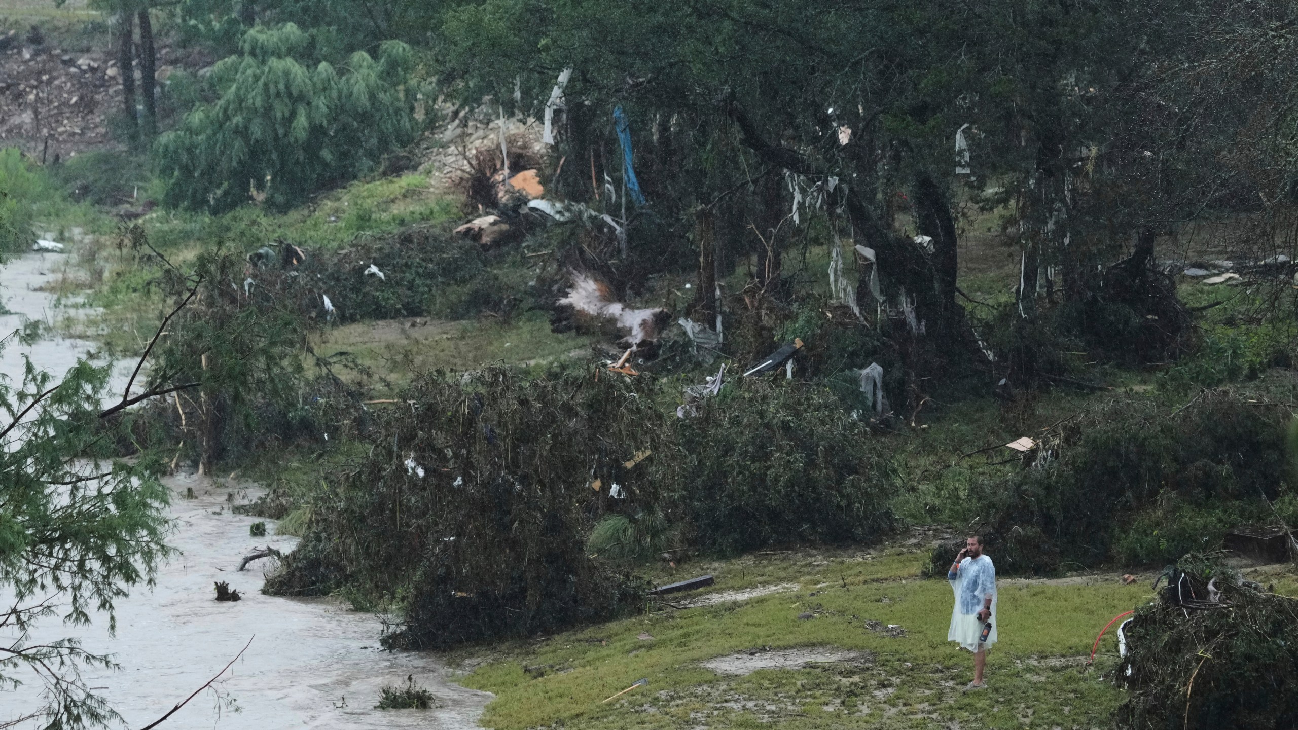 A man surveys damage left by a raging Guadalupe River, Friday, July 4, 2025, in Kerrville, Texas. (AP Photo/Eric Gay)