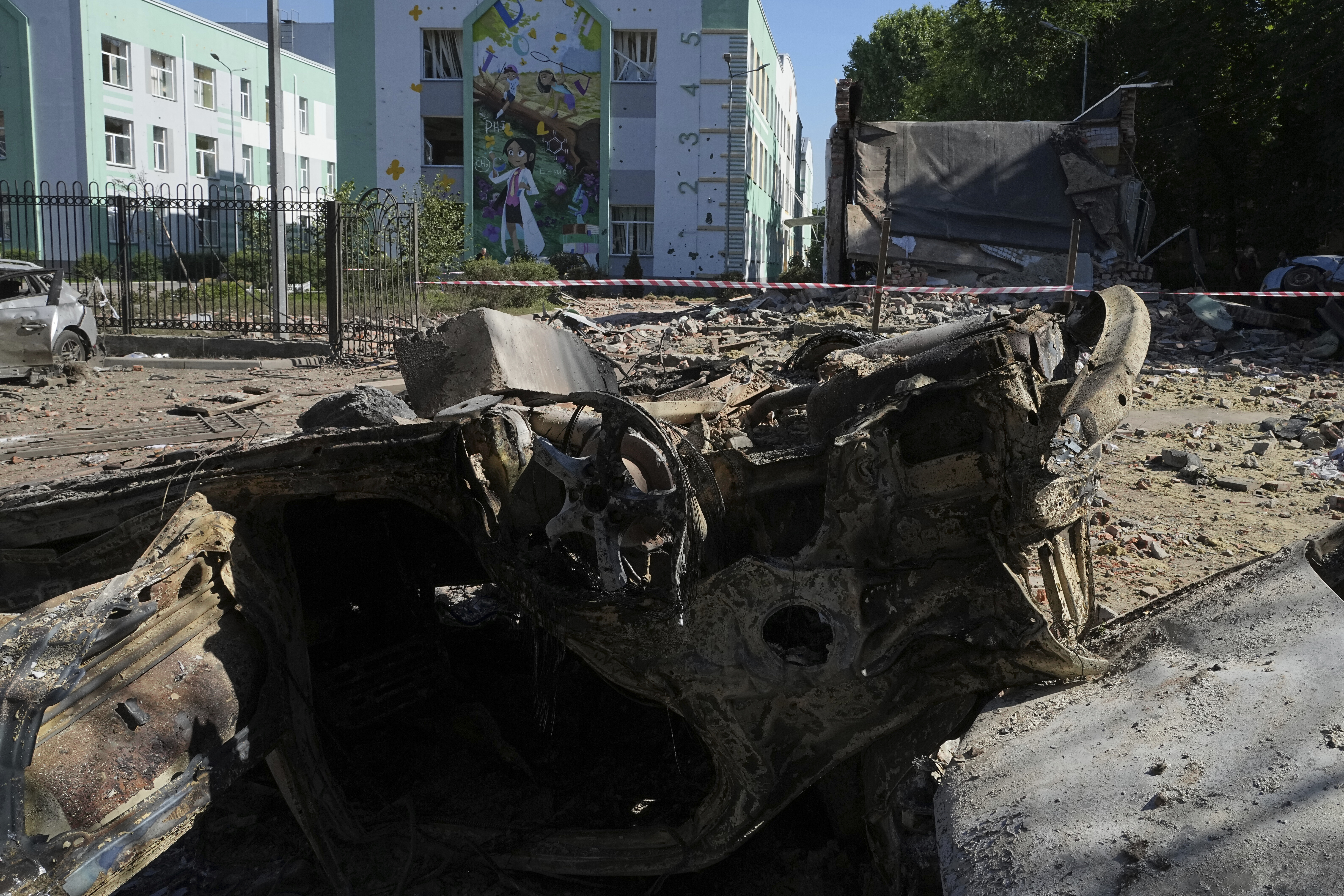 Damaged cars lie in a yard among other debris after a Russian drone and missile attacks in Kyiv, Ukraine, Friday, July 4, 2025. (AP Photo/Efrem Lukatsky)