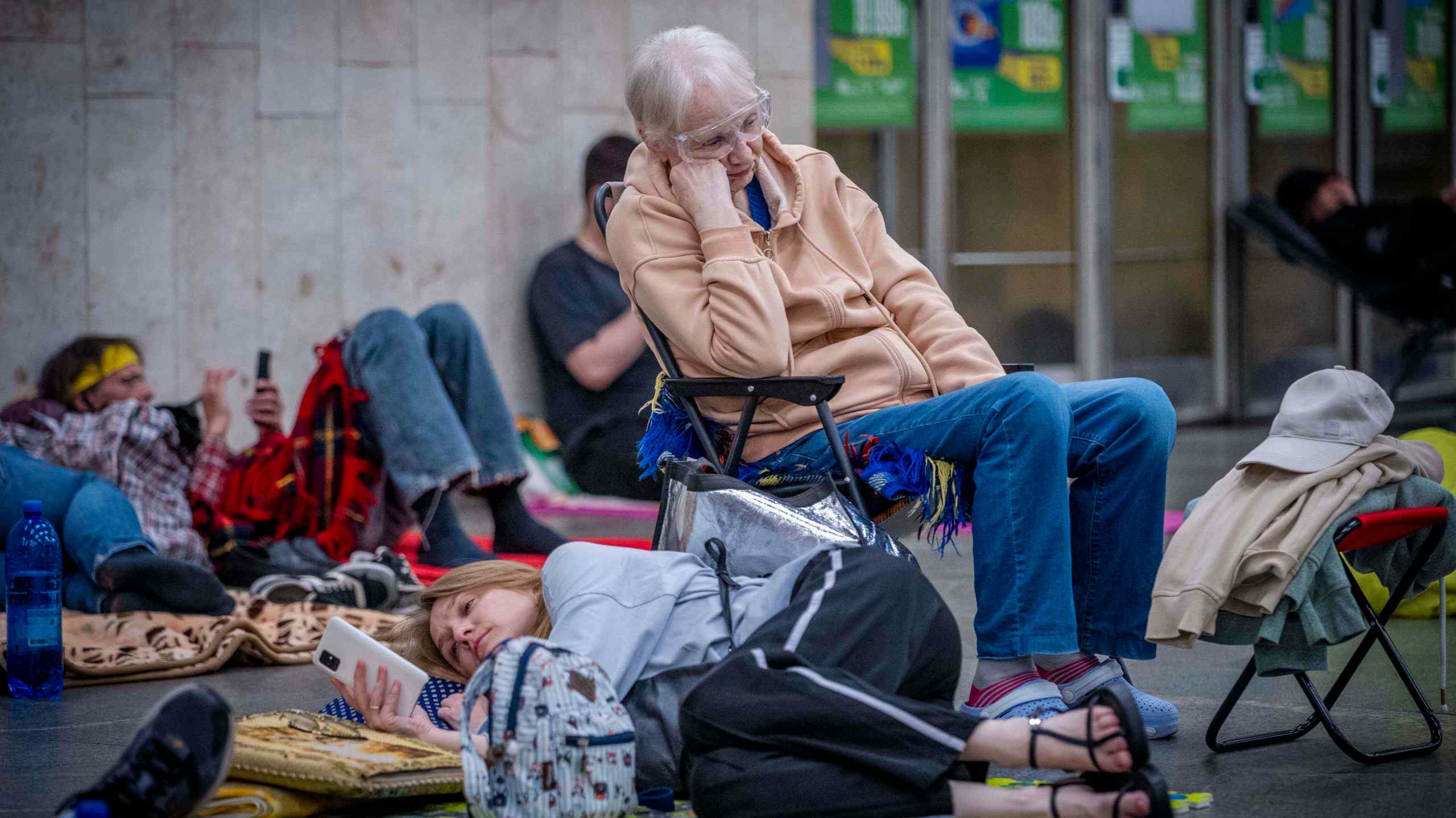 People hide in a metro station, being used as a bomb shelter, during a Russian drones attack in Kyiv, Ukraine, early hours Saturday, July 5, 2025. (AP Photo/Dan Bashakov)