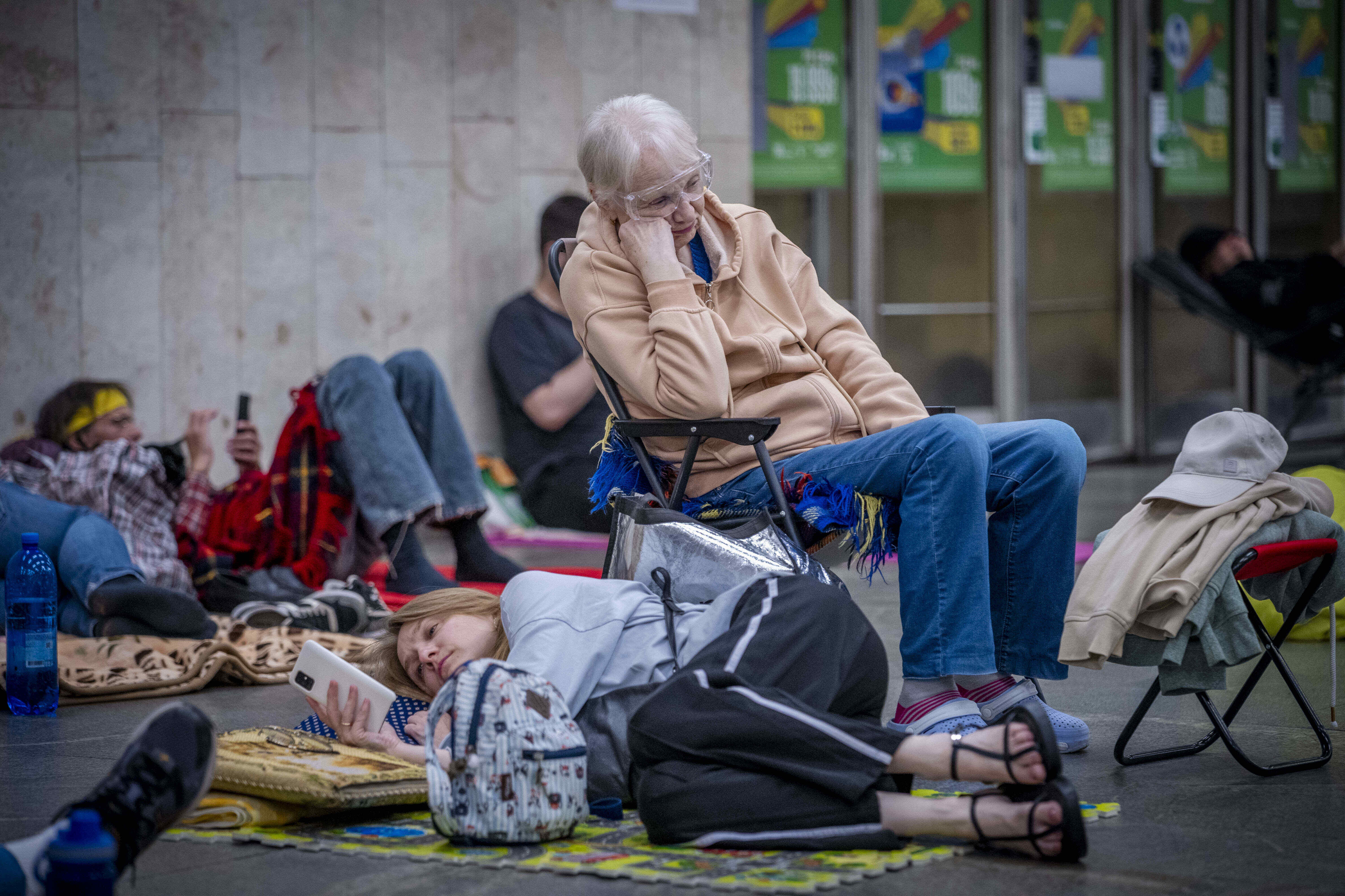 People hide in a metro station, being used as a bomb shelter, during a Russian drones attack in Kyiv, Ukraine, early hours Saturday, July 5, 2025. (AP Photo/Dan Bashakov)