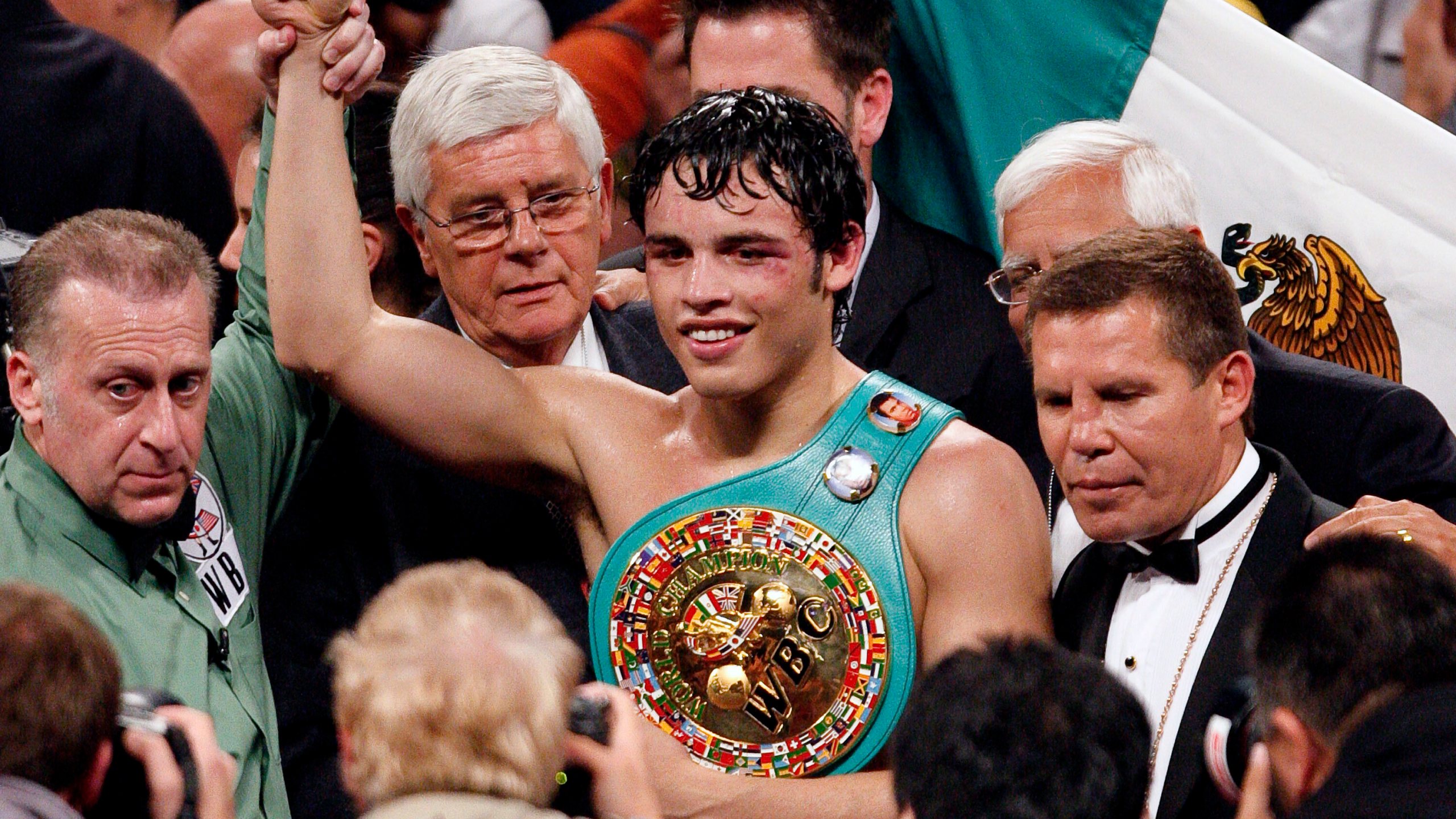 FILE - Julio Cesar Chavez, Jr., center, of Mexico poses with his belt along with his father Julio Cesar Chavez, Sr., right, and referee Jack Reiss after defeating Sebastian Zbik of Germany after their WBC World Middleweight title boxing match, in Los Angeles, June 4, 2011. (AP Photo/Richard Vogel, File)