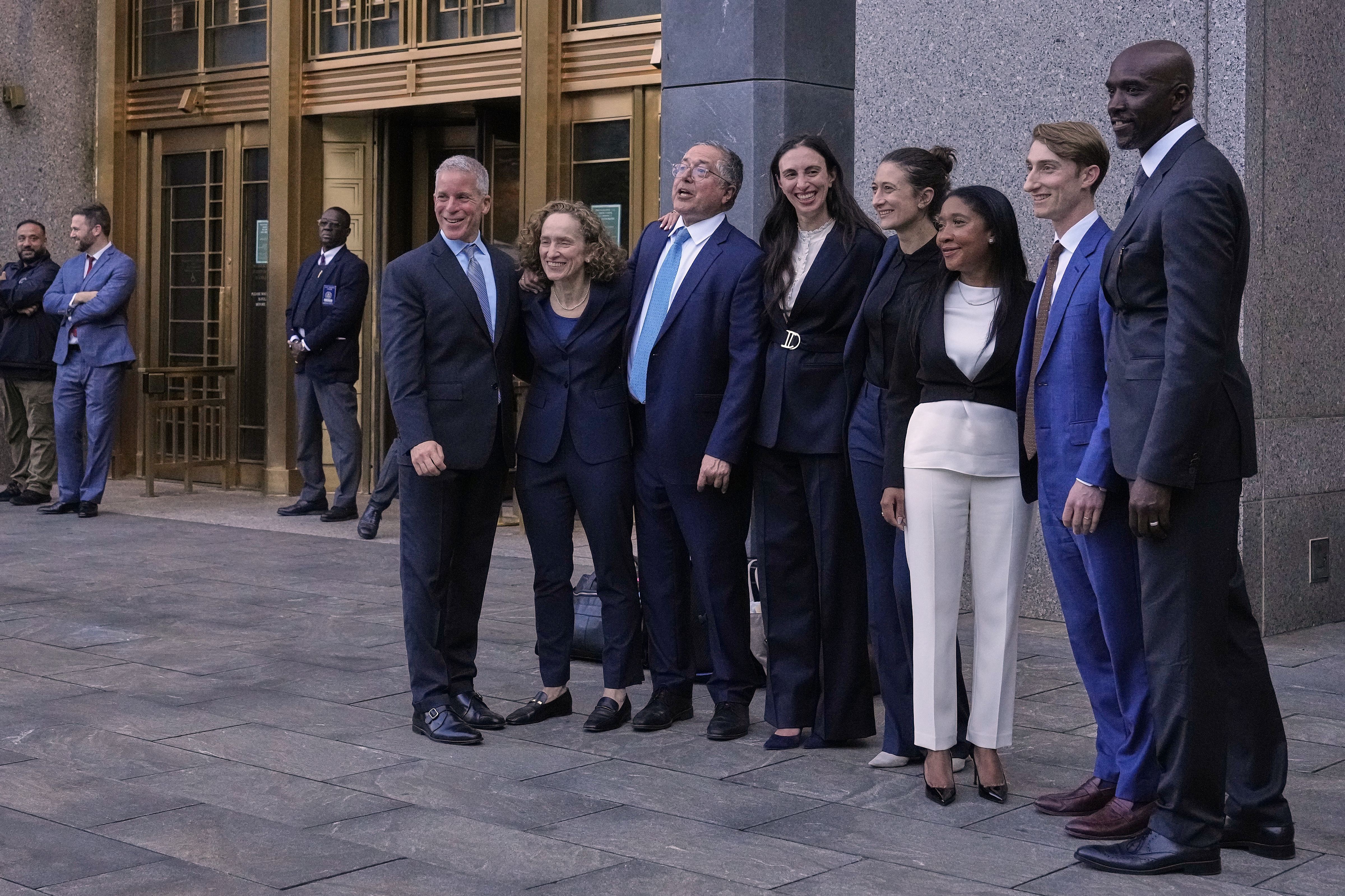 Defense attorneys for Sean "Diddy" Combs, including from left, Brian Steel, Alexandra Shapiro, Marc Agnifilo and Teny Garagos, Anna Estevao, Nicole Westmoreland and Xavier Donaldson, far right, line up for a group photo outside Manhattan federal court after Sean "Diddy" Combs was denied bail after being convicted of prostitution-related offenses but acquitted of sex trafficking and racketeering charges, Wednesday, July 2, 2025, in New York. (AP Photo/Yuki Iwamura)