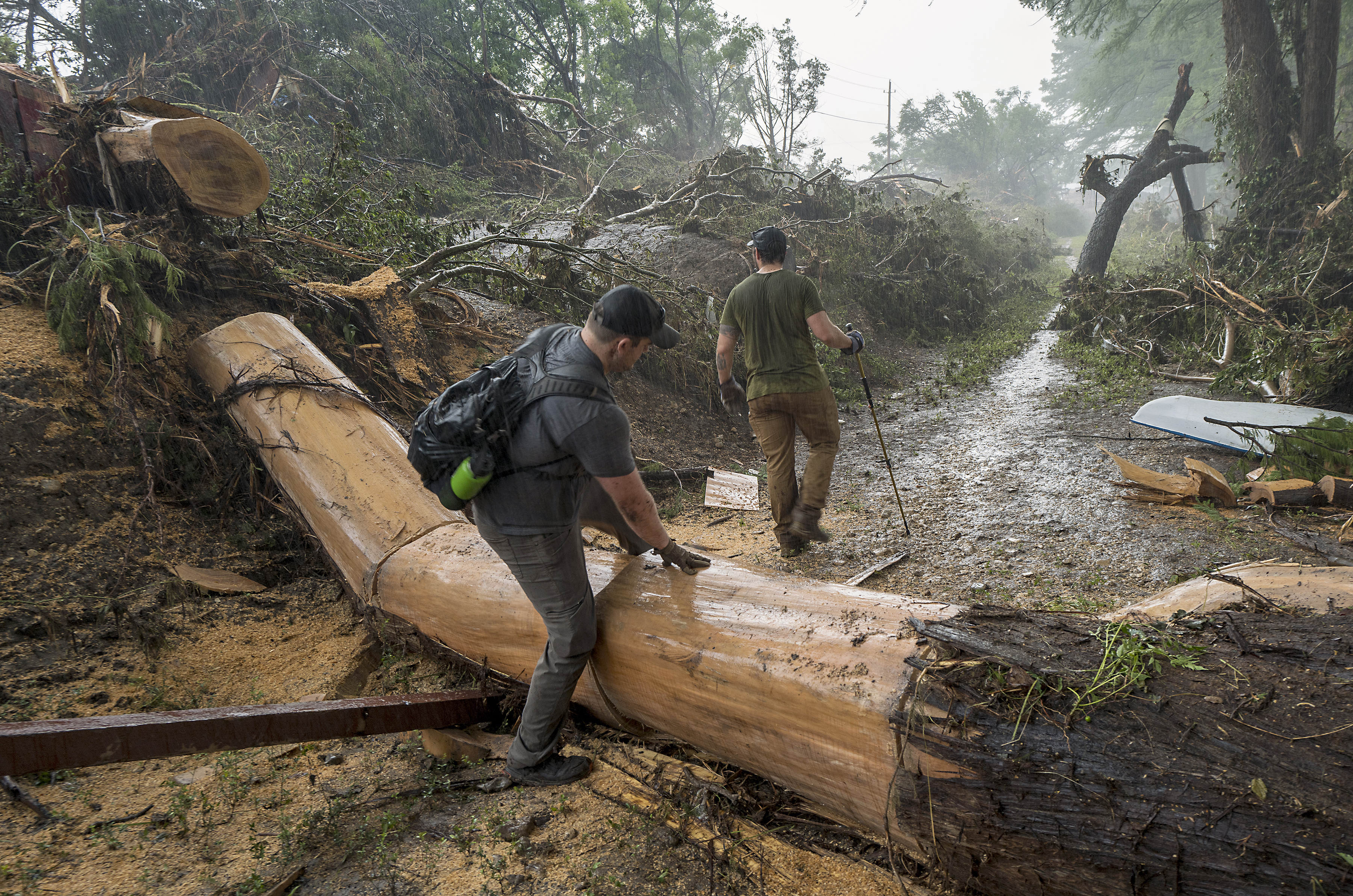 Volunteers search for missing people along the banks of the Guadalupe River after recent flooding on Sunday, July 6, 2025, in Hunt, Texas. (AP Photo/Rodolfo Gonzalez)