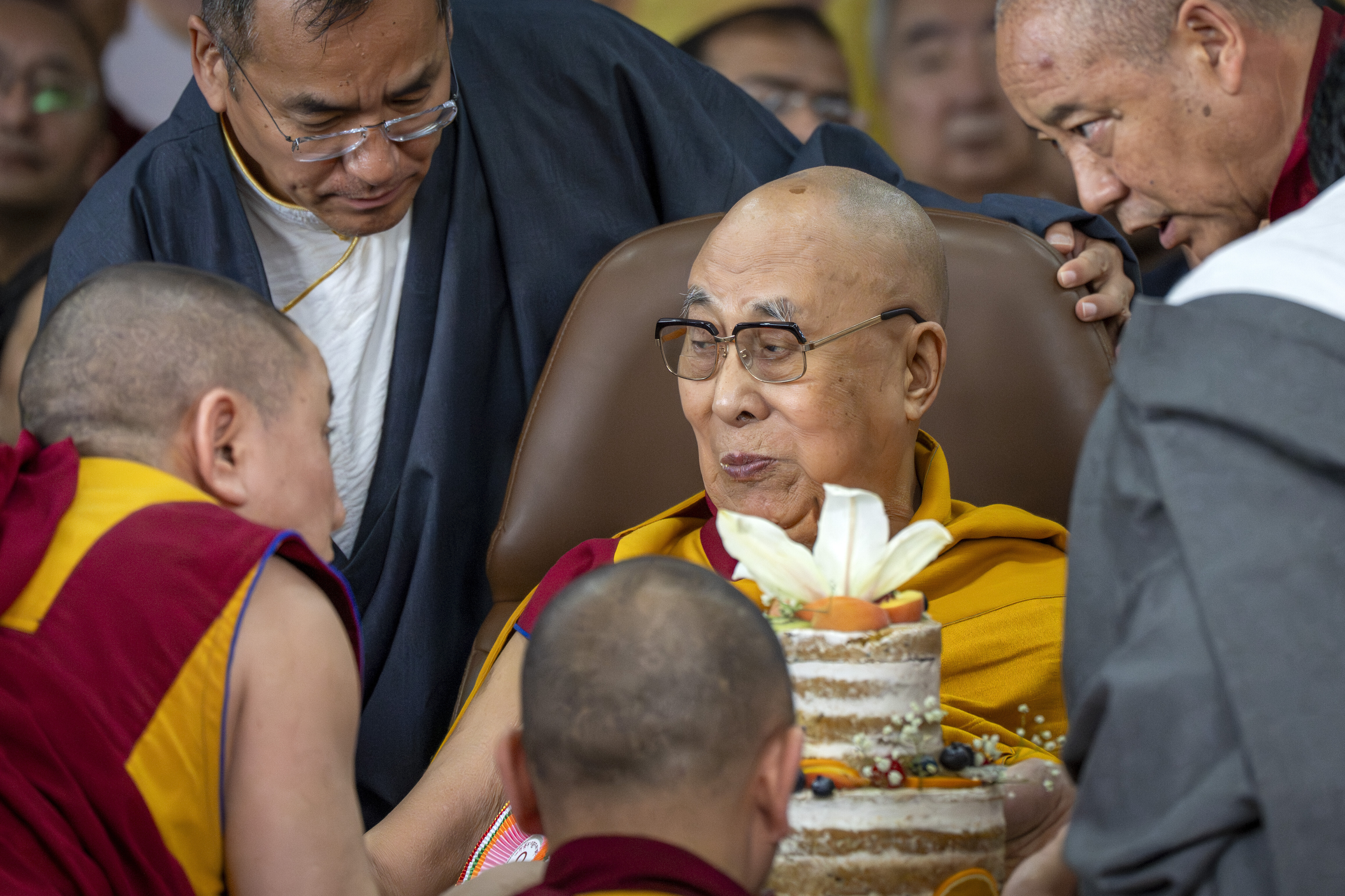 Tibetan spiritual leader the Dalai Lama eats a cake during his 90th birthday celebrations at the Tsuglakhang temple in Dharamshala, India, Sunday, July 6, 2025.(AP Photo/Ashwini Bhatia)