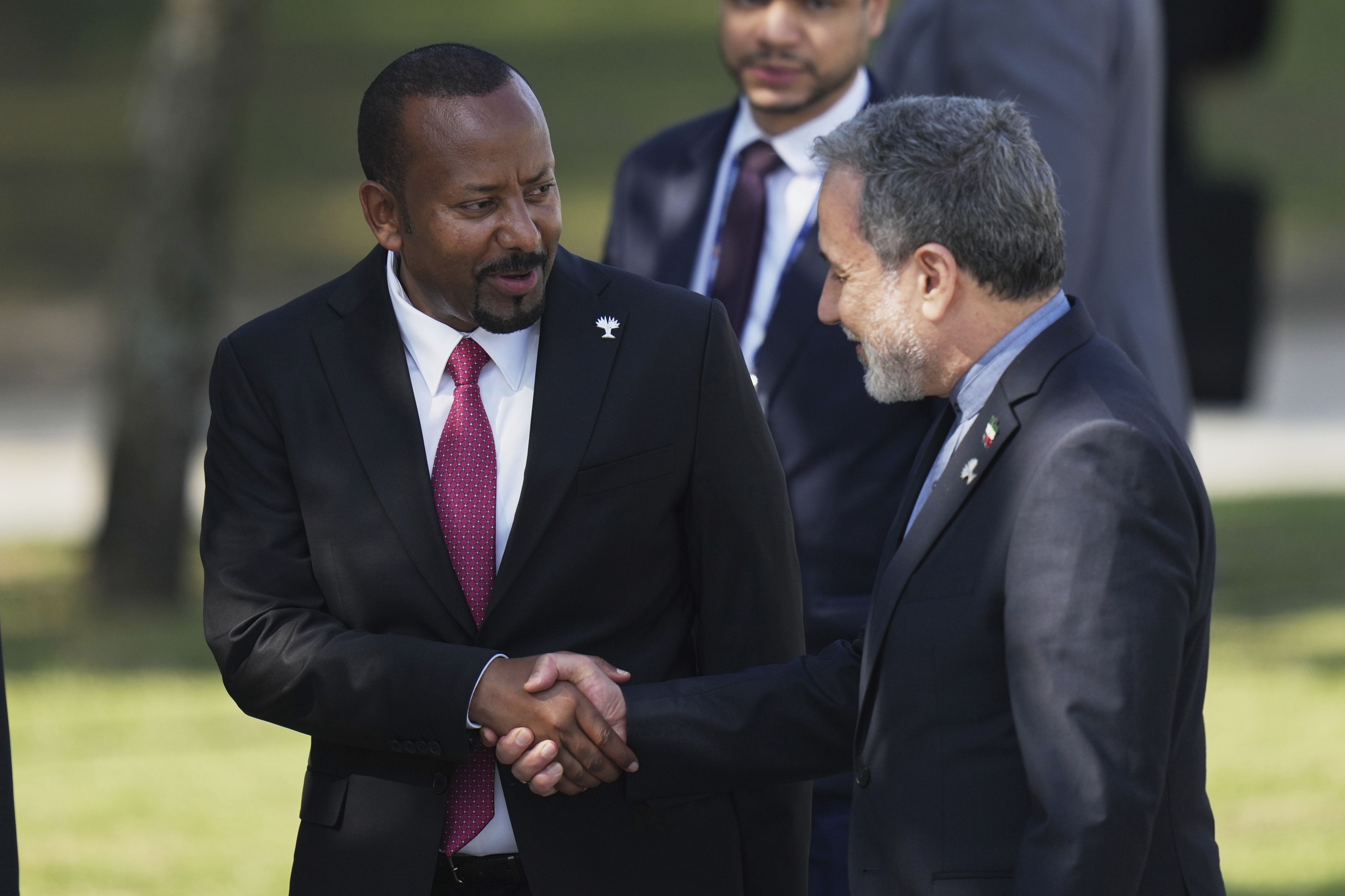 Prime Minister of Ethiopia Abiy Ahmed, left, shakes hands with Iranian Foreign Minister Abbas Araghchi during the 17th annual BRICS summit in Rio de Janeiro, Sunday, July 6, 2025. (AP Photo/Silvia Izquierdo)