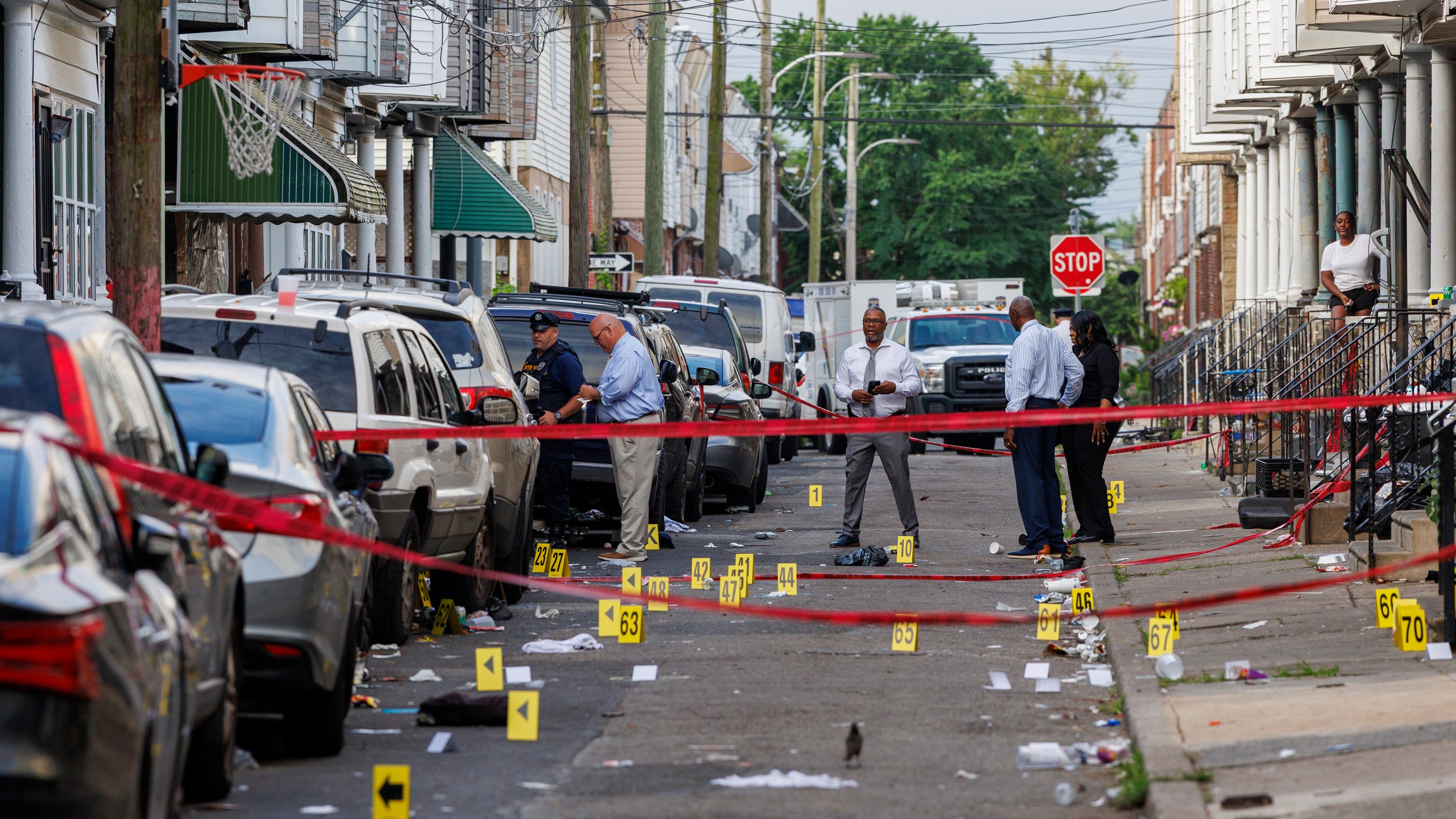 Crime scene evidence markers line a street in Philadelphia after an overnight shooting, early Monday, July 7, 2025. (Alejandro A. Alvarez/The Philadelphia Inquirer via AP)