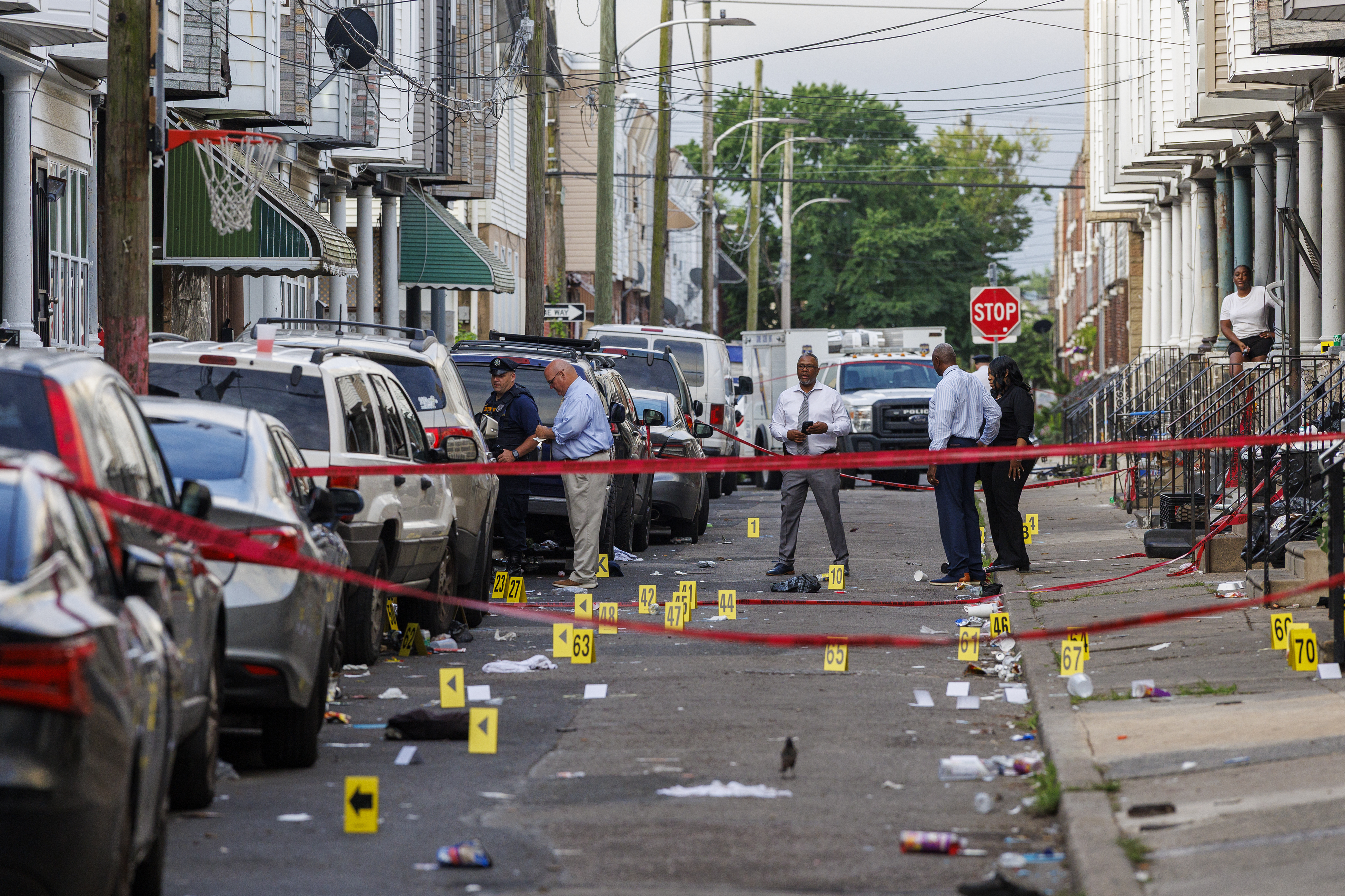Crime scene evidence markers line a street in Philadelphia after an overnight shooting, early Monday, July 7, 2025. (Alejandro A. Alvarez/The Philadelphia Inquirer via AP)