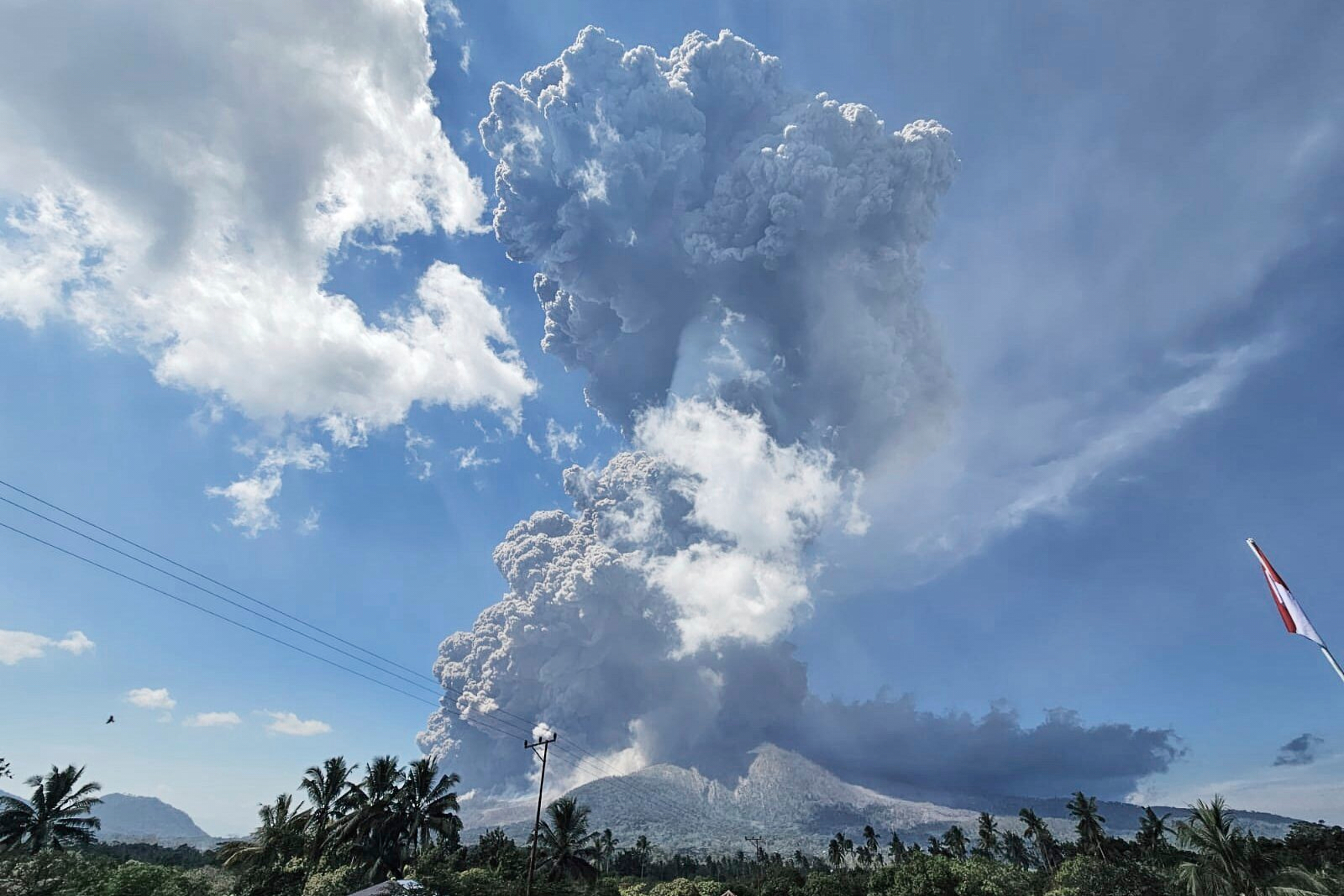 In photo released by Geological Agency (Badan Geologi) of the Indonesia's Ministry of Energy and Mineral Resources, Mount Lewotobi Laki-Laki spews volcanic materials during an eruption in East Flores, Indonesia, Monday, July 7, 2025. (Badan Geologi via AP)