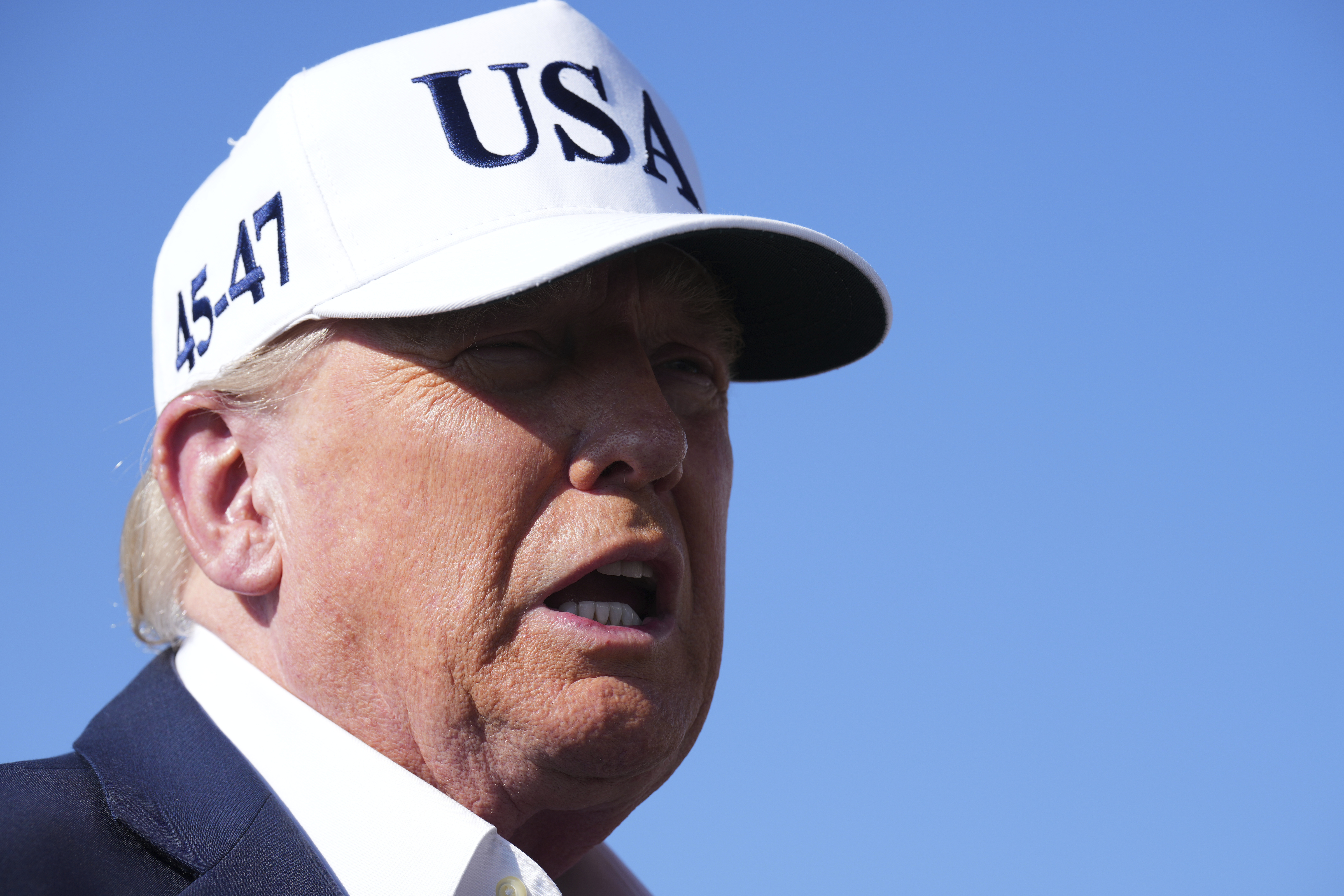 President Donald Trump speaks with reporters before boarding Air Force One at Morristown Municipal Airport in Morristown, N.J., Sunday, July 6, 2025, en route to Washington. (AP Photo/Jacquelyn Martin)