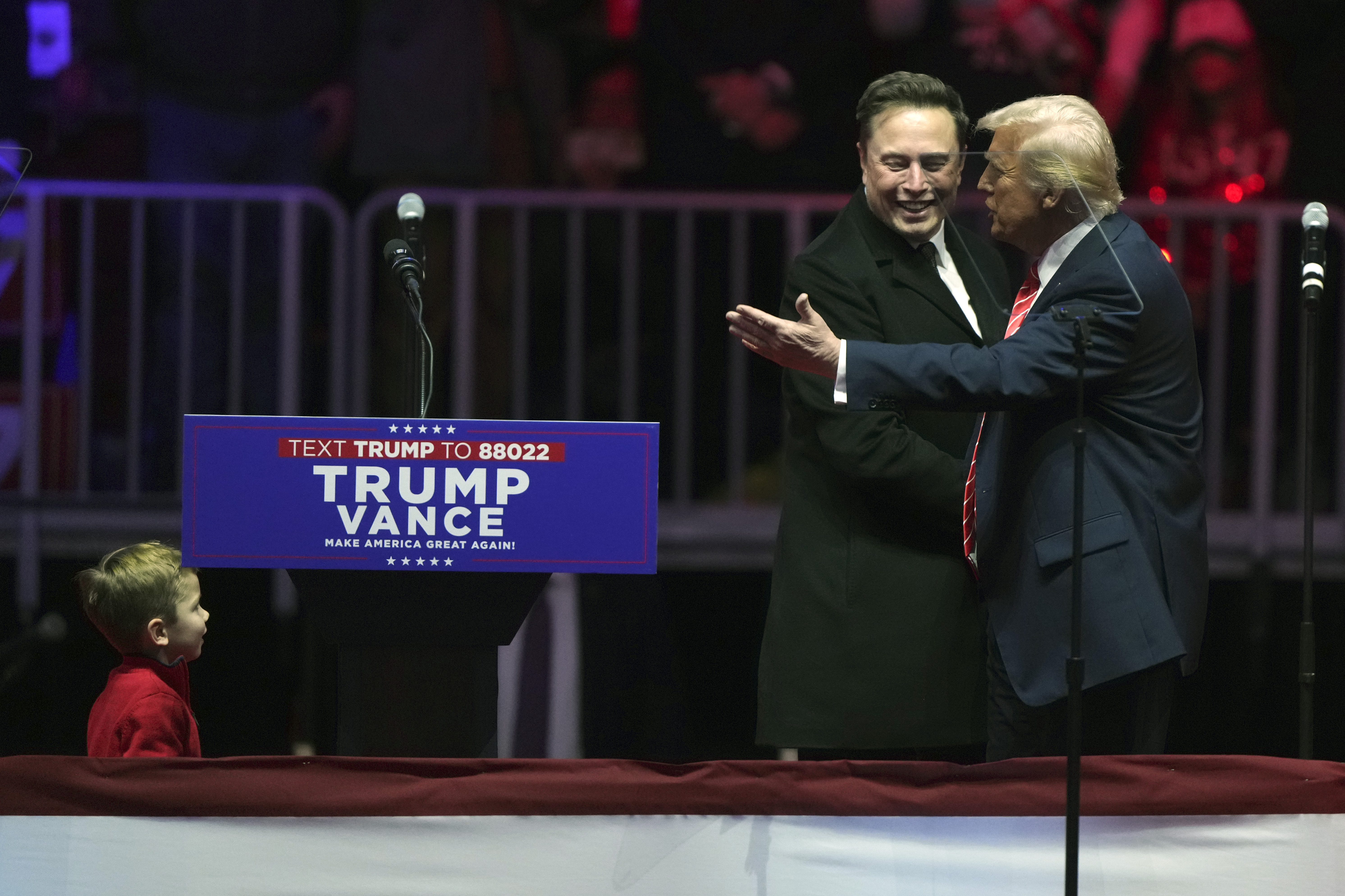 FILE - Elon Musk, with his son X Æ A-Xii, arrives on the dais with President-elect Donald Trump, at a rally ahead of the 60th Presidential Inauguration, Jan. 19, 2025, in Washington. (AP Photo/Matt Rourke, File)