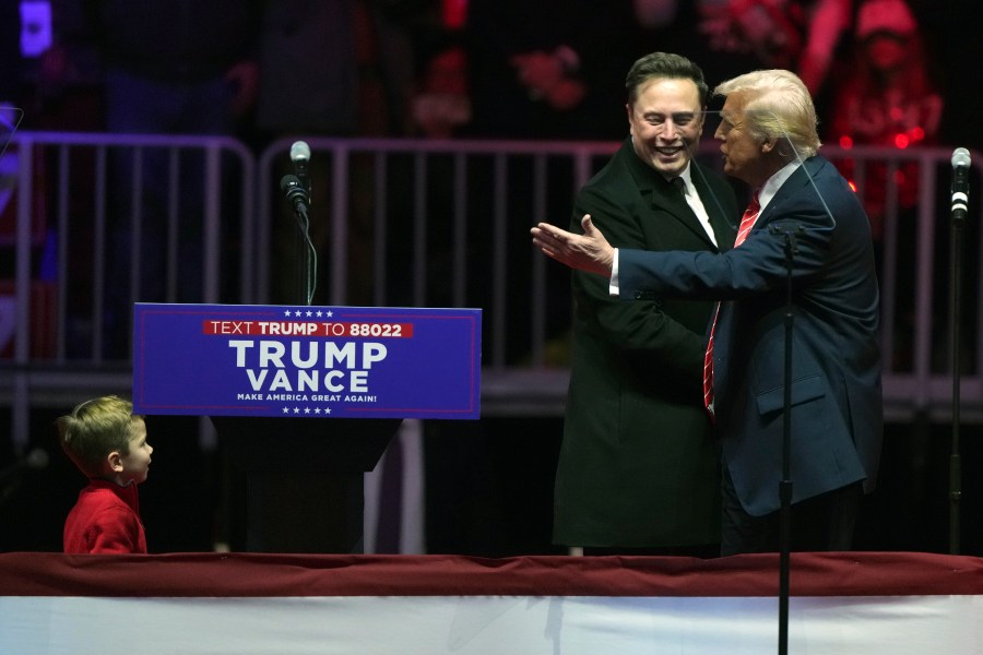 FILE - Elon Musk, with his son X Æ A-Xii, arrives on the dais with President-elect Donald Trump, at a rally ahead of the 60th Presidential Inauguration, Jan. 19, 2025, in Washington. (AP Photo/Matt Rourke, File)