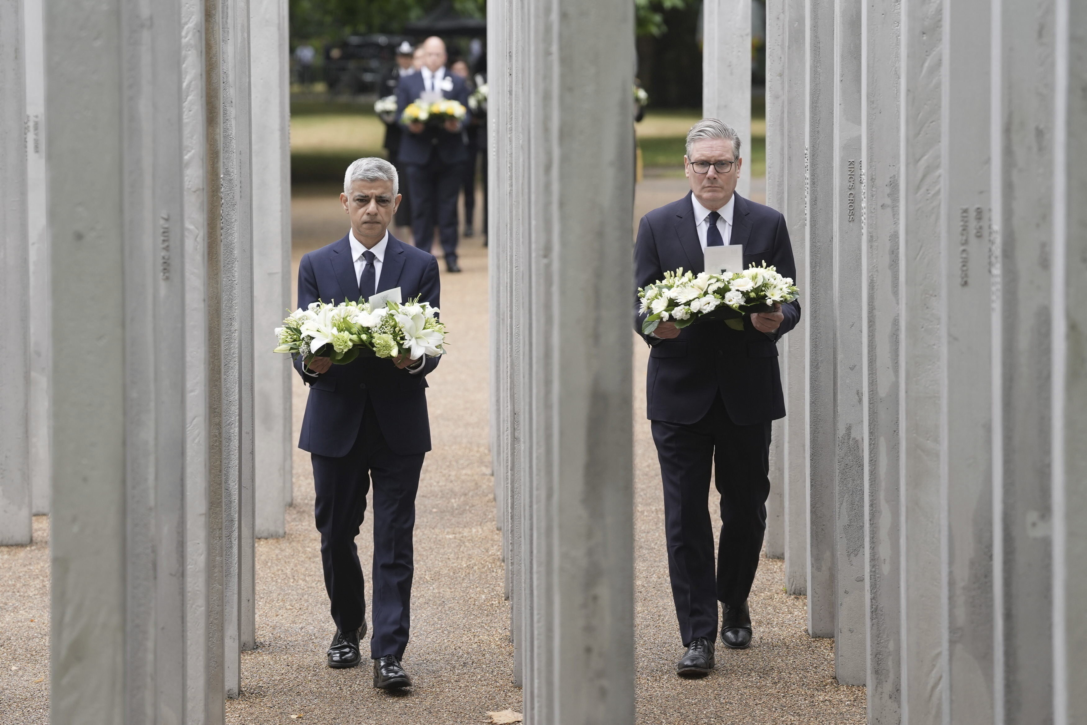 Mayor of London Sadiq Khan, left, and Britain's Prime Minister Keir Starmer lay a wreath at the 7/7 Memorial, in Hyde Park to mark the anniversary of the terrorist attacks in London July 7, 2005 that killed 52 people, in London, Monday July 7, 2025. (Stefan Rousseau/PA via AP)