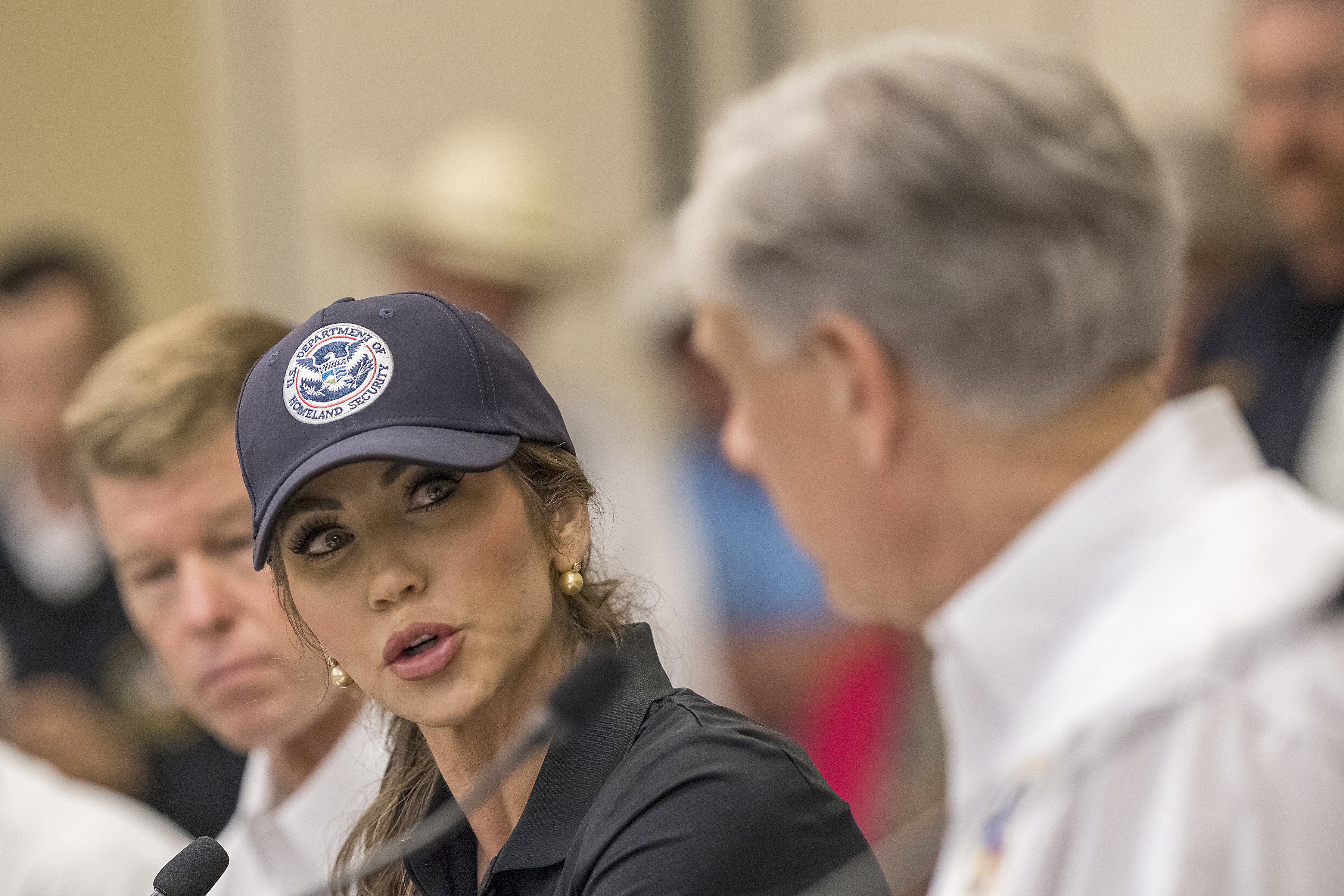 CORRECTS TO KERRVILLE, NOT INGRAM - Homeland Security Secretary Kristi Noem, center, speaks with Texas Gov. Greg Abbott, right, about ongoing search and rescue efforts after recent flooding along the Guadalupe River during a press conference on Saturday, July 5, 2025, in Kerrville, Texas. (AP Photo/Rodolfo Gonzalez)