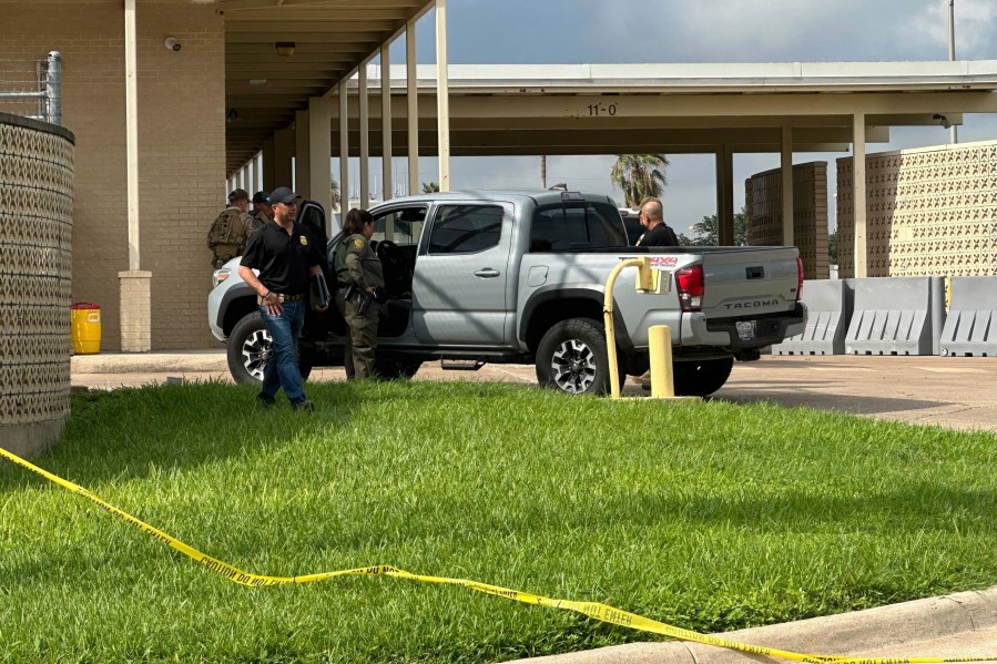 Officials work the scene of a shooting at a Border Patrol facility in McAllen, Texas, Monday, July 7, 2025. (AP Photo/Valerie Gonzalez)
