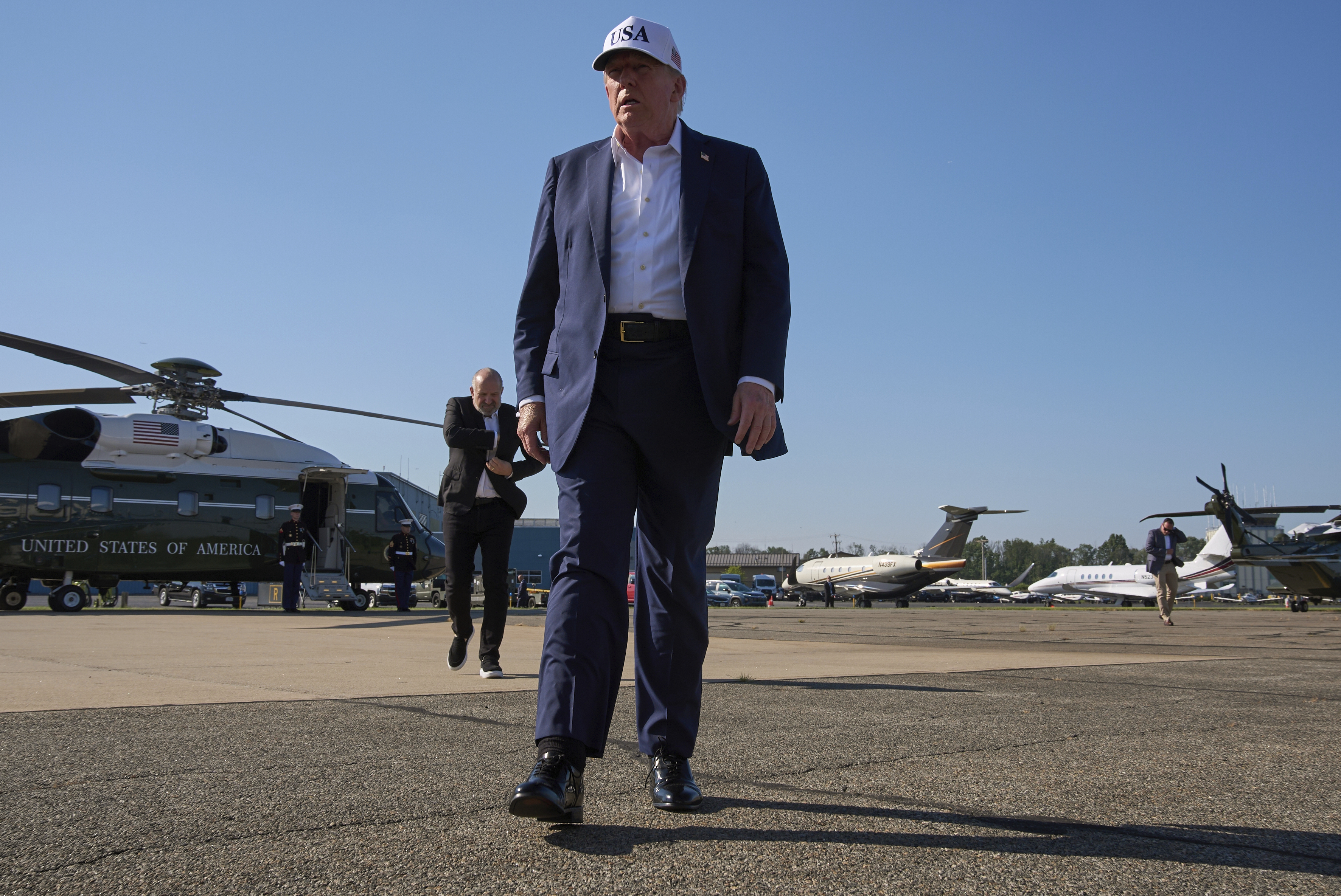 President Donald Trump walks toward the media to speak with them before boarding Air Force One, at Morristown Municipal Airport in Morristown, N.J., Sunday, July 6, 2025, en route to Washington after a weekend in New Jersey. (AP Photo/Jacquelyn Martin)