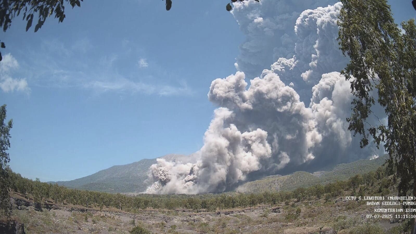 ADDS DETAILS OF THE DIGITAL IMPRINTS AT LOWER RIGHT - In photo released by the Geological Agency (Badan Geologi) of the Indonesia's Ministry of Energy and Mineral Resources, Mount Lewotobi Laki Laki spews volcanic materials during an eruption in East Flores, Indonesia, Monday, July 7, 2025. The watermark at the lower right corner reads: CCTV Mount Lewotobi, Geological Agency, Ministry of Energy and Mineral Resources, with the date and time. (Badan Geologi via AP)