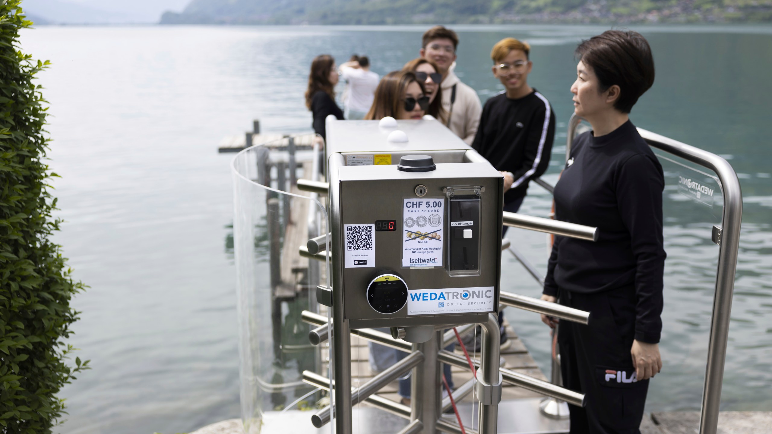 Korean visitors get on the pier at Lake Brienz after paying 5 Swiss Francs in Iseltwald, Switzerland, Sunday, May 21, 2023. (Peter Klaunzer/Keystone via AP)