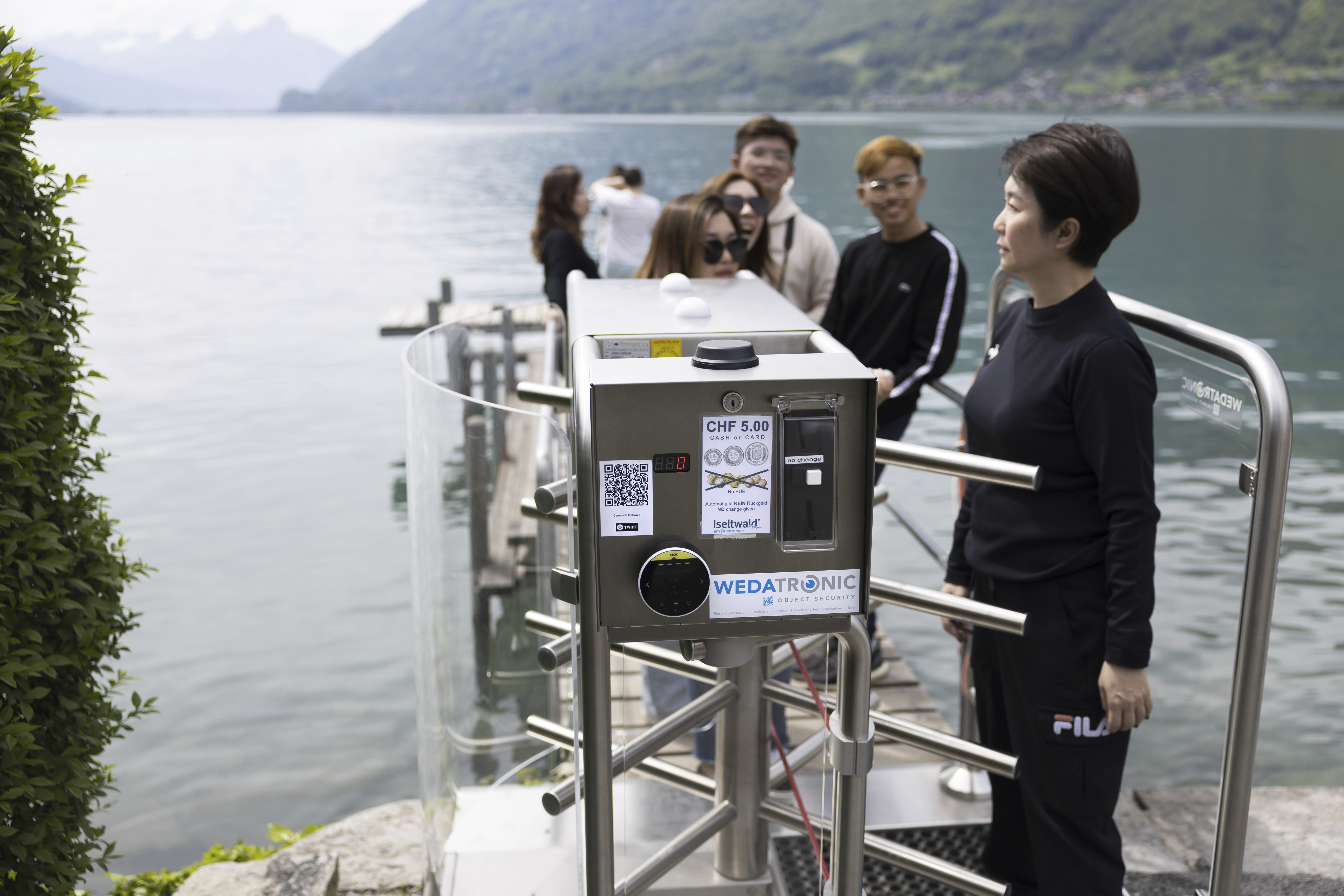 Korean visitors get on the pier at Lake Brienz after paying 5 Swiss Francs in Iseltwald, Switzerland, Sunday, May 21, 2023. (Peter Klaunzer/Keystone via AP)