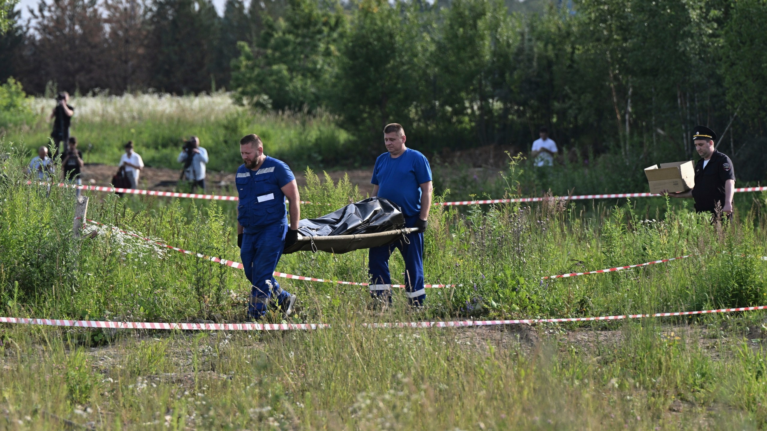 Russian law enforcement agents carry the body of former Transportation Minister Roman Starovoit, who was found dead from a gunshot wound in an apparent suicide, investigators said Monday, hours after his dismissal in Odintsovo, outside Moscow, Russia, Monday, July 7, 2025. (Evgeniy Razumniy/Kommersant Photo via AP)