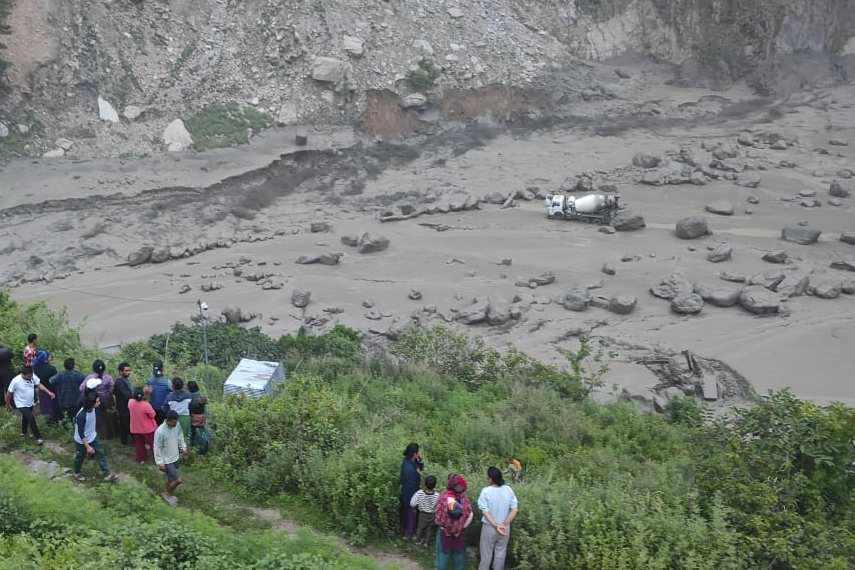 People watch the damage caused by flooding on the Bhotekoshi River 120 kilometers (75 miles) north of Kathmandu, Nepal, Tuesday, July 8, 2025. (Nepal Army via AP)