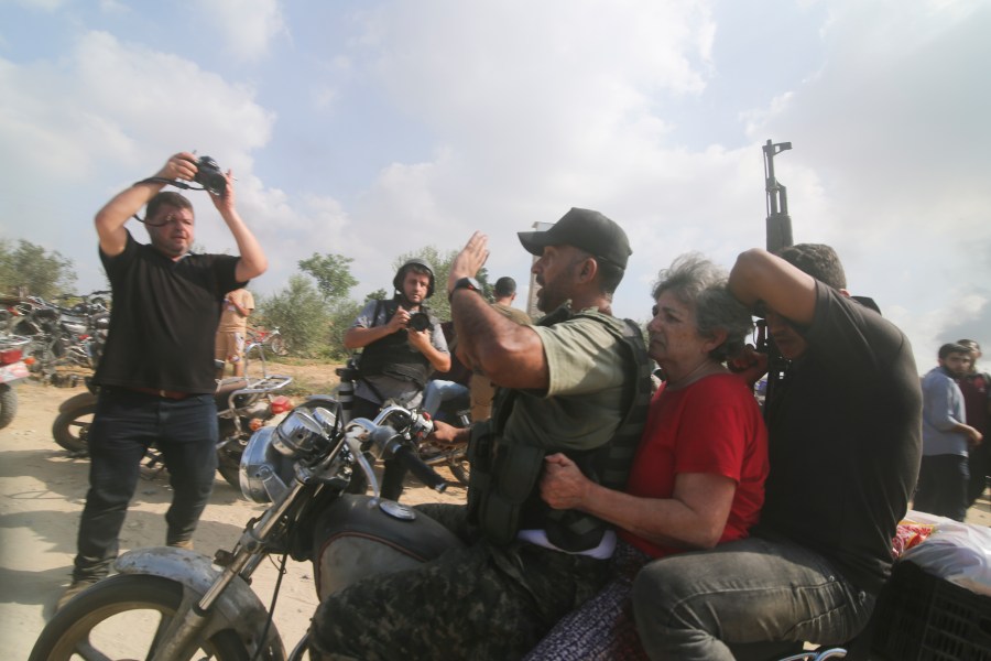 FILE -Hamas militants transport Adina Moshe, 72, inside the Gaza Strip after kidnapping her from her home in Nir Oz, a kibbutz in Israel near the Gaza border, on Oct. 7, 2023. (AP Photo), File)