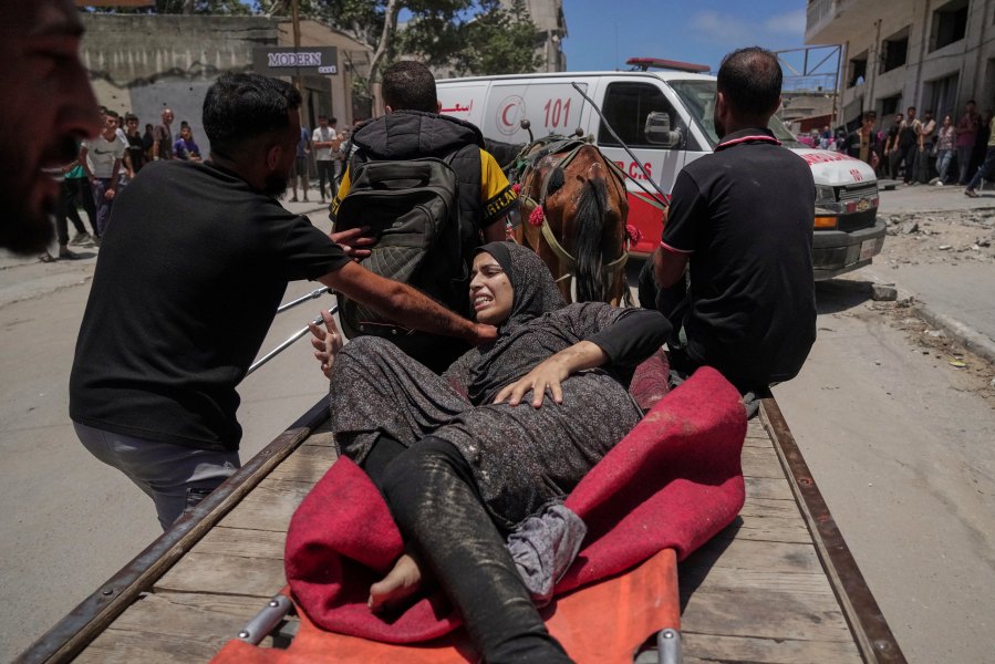 A woman is evacuated after an Israeli strike on tents sheltering displaced Palestinians in Gaza City on Tuesday, July 8, 2025. (AP Photo/Jehad Alshrafi)