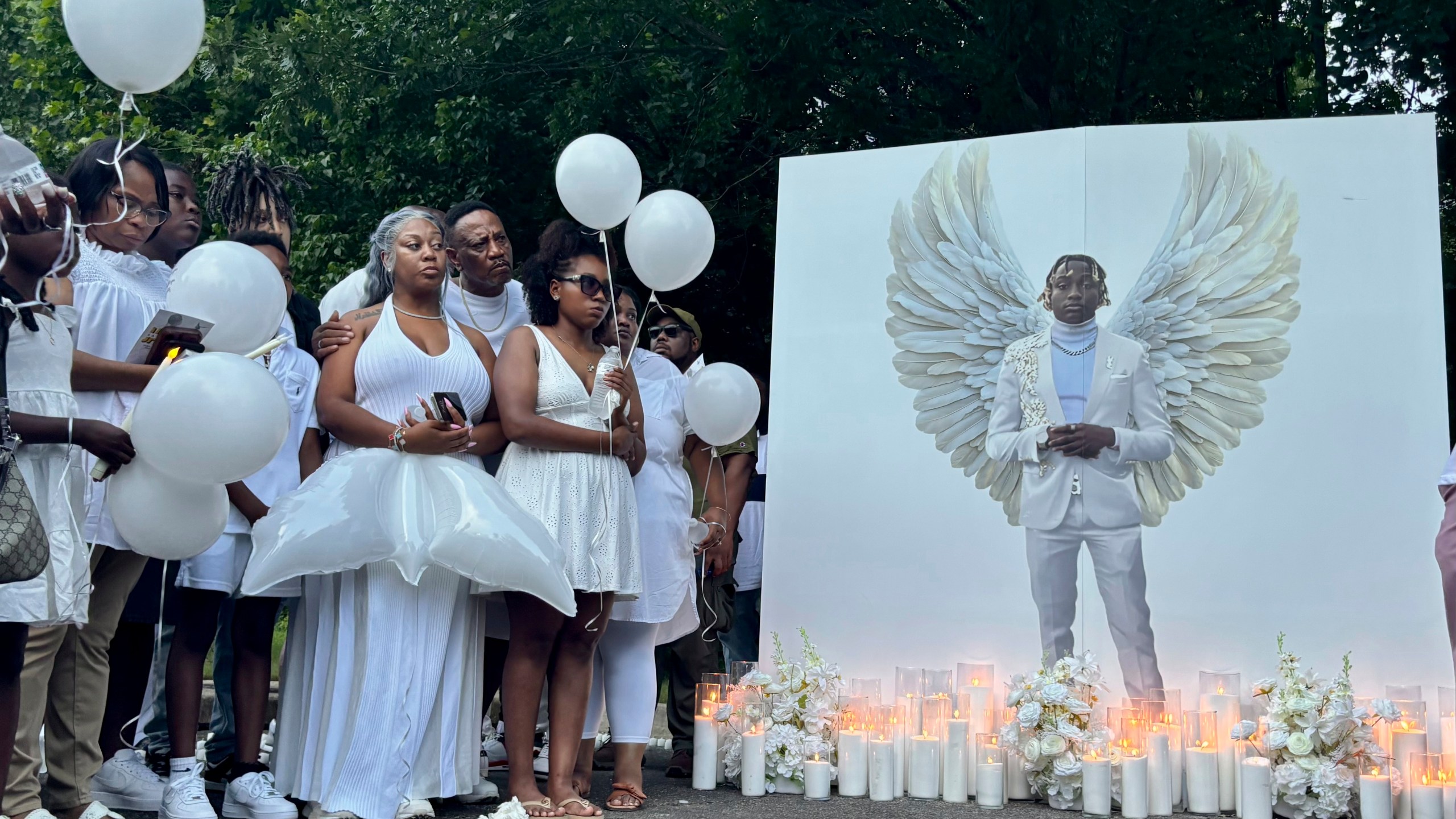 Family members of Jabari Peoples hold balloons at a candlelight vigil in Homewood, Ala., Monday, June 30, 2025. Peoples, 18, was shot and killed by police at the spot at a Homewood soccer field complex on Monday, June 23. (AP Photo/Kim Chandler)