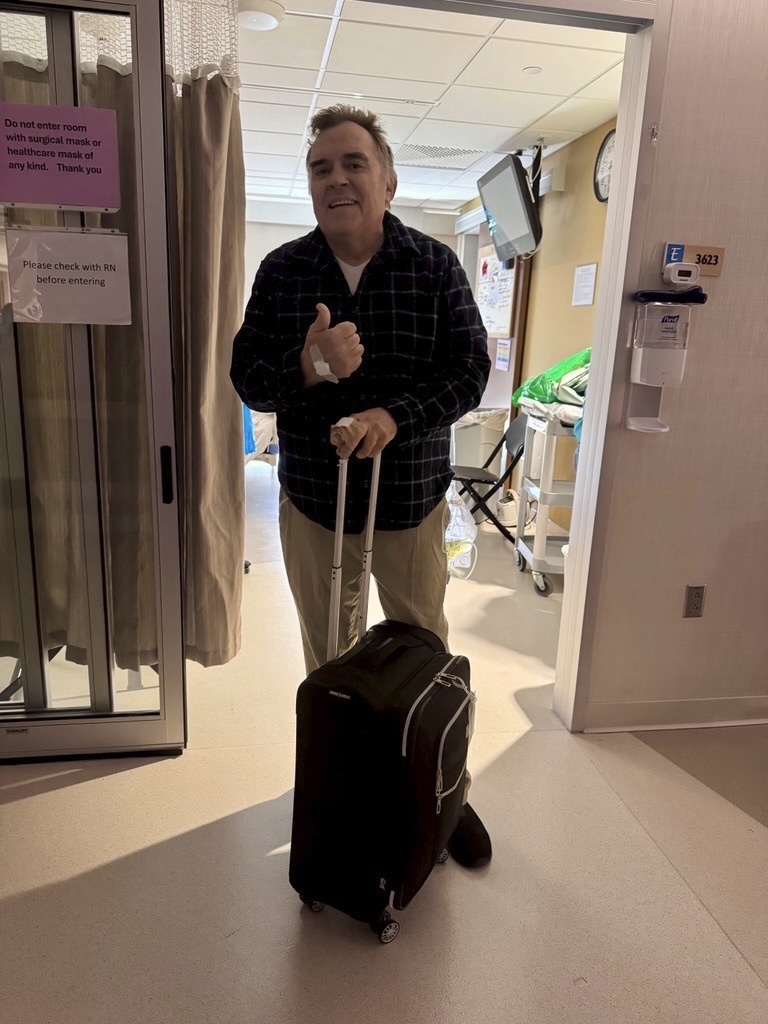 This photo provided by shows Sen. John Hoffman gives a thumps up as he was moved from a hospital to a rehabilitation facility on Monday, July 7, 2025. (Courtesy of the Hoffman family via AP)