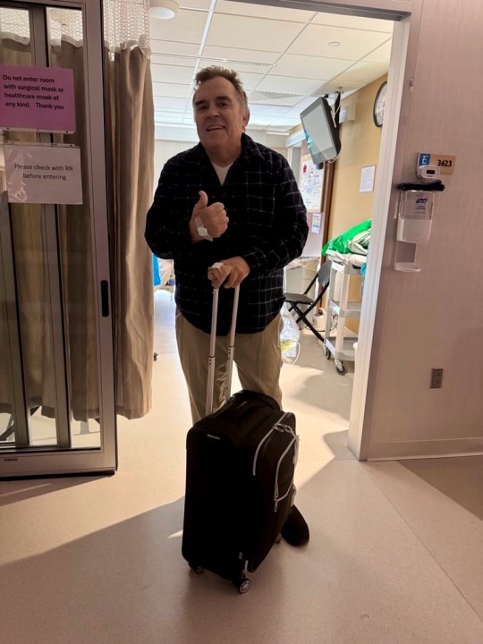 This photo provided by shows Sen. John Hoffman gives a thumps up as he was moved from a hospital to a rehabilitation facility on Monday, July 7, 2025. (Courtesy of the Hoffman family via AP)