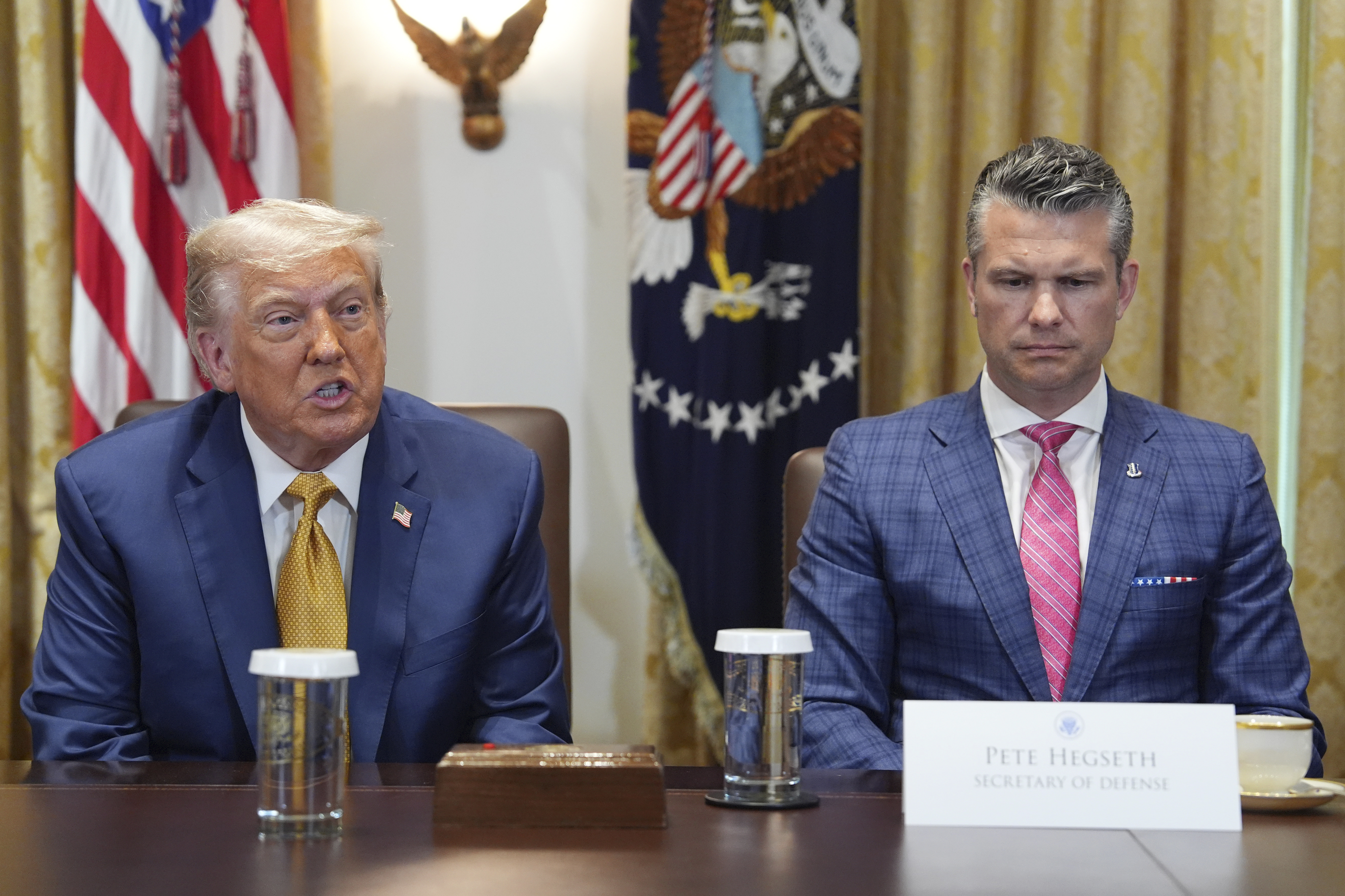 President Donald Trump, left, with Defense Secretary Pete Hegseth, right, during a cabinet meeting at the White House, Tuesday, July 8, 2025, in Washington. (AP Photo/Evan Vucci)