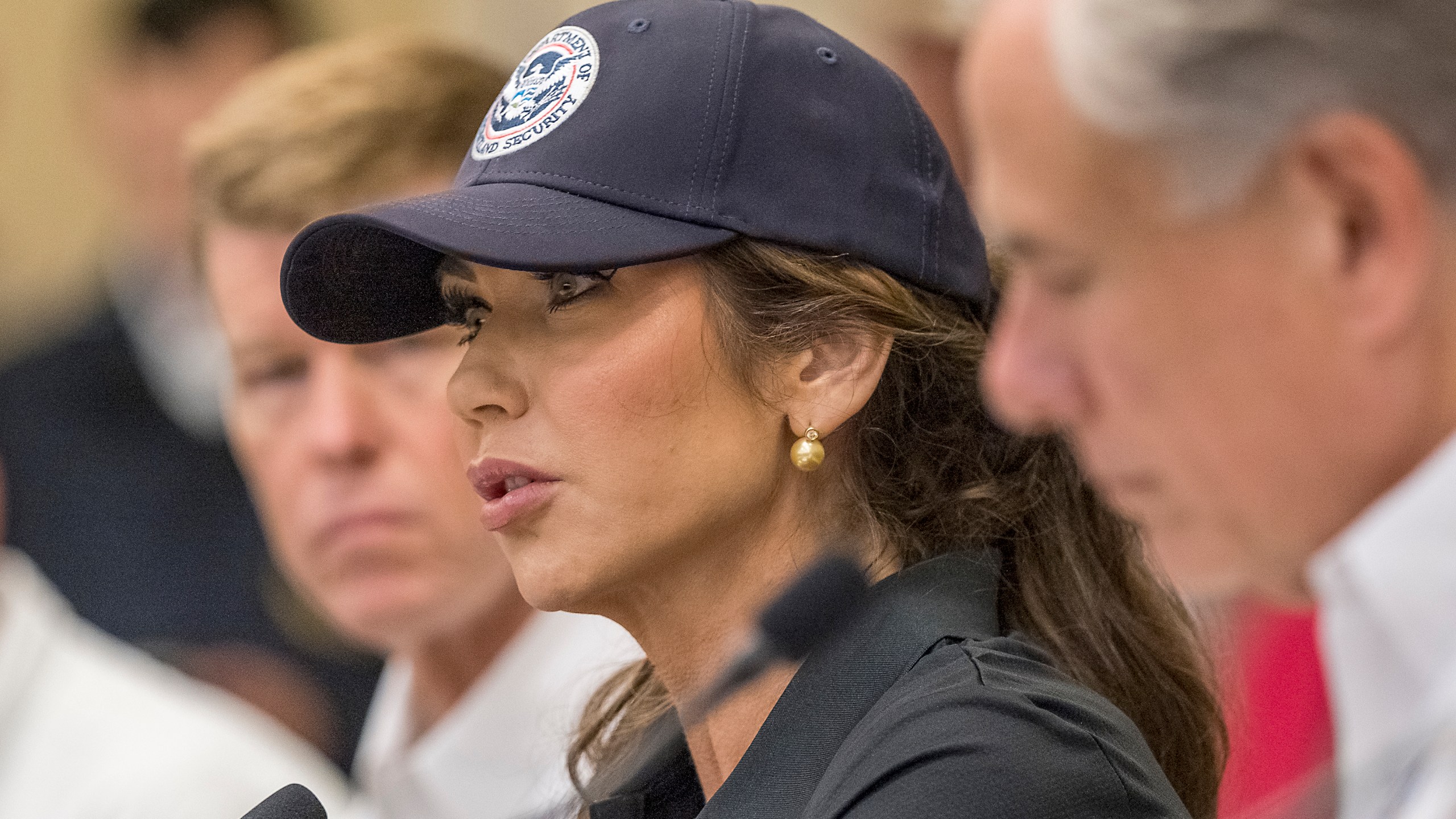 Homeland Security Secretary Kristi Noem, center, and Texas Gov. Greg Abbott, right, discuss the ongoing search and rescue efforts after recent flooding along the Guadalupe River during a press conference on Saturday, July 5, 2025, in Kerrville, Texas. (AP Photo/Rodolfo Gonzalez)