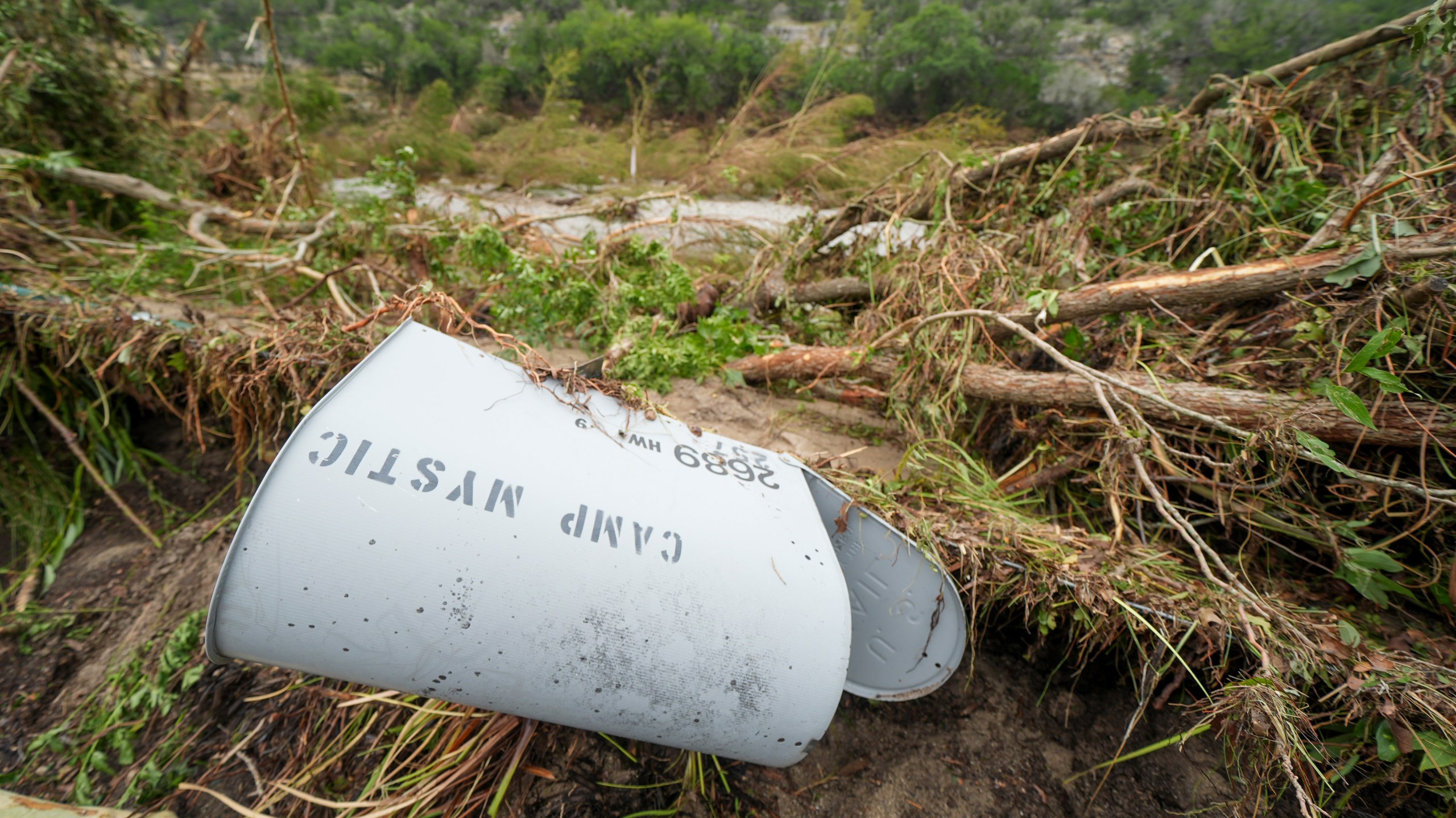 A Camp Mystic mailbox lies near the entrance to the camp along the banks of the Guadalupe River, Saturday, July 5, 2025, in Hunt, Texas, after a flash flood swept through the area. (AP Photo/Julio Cortez)