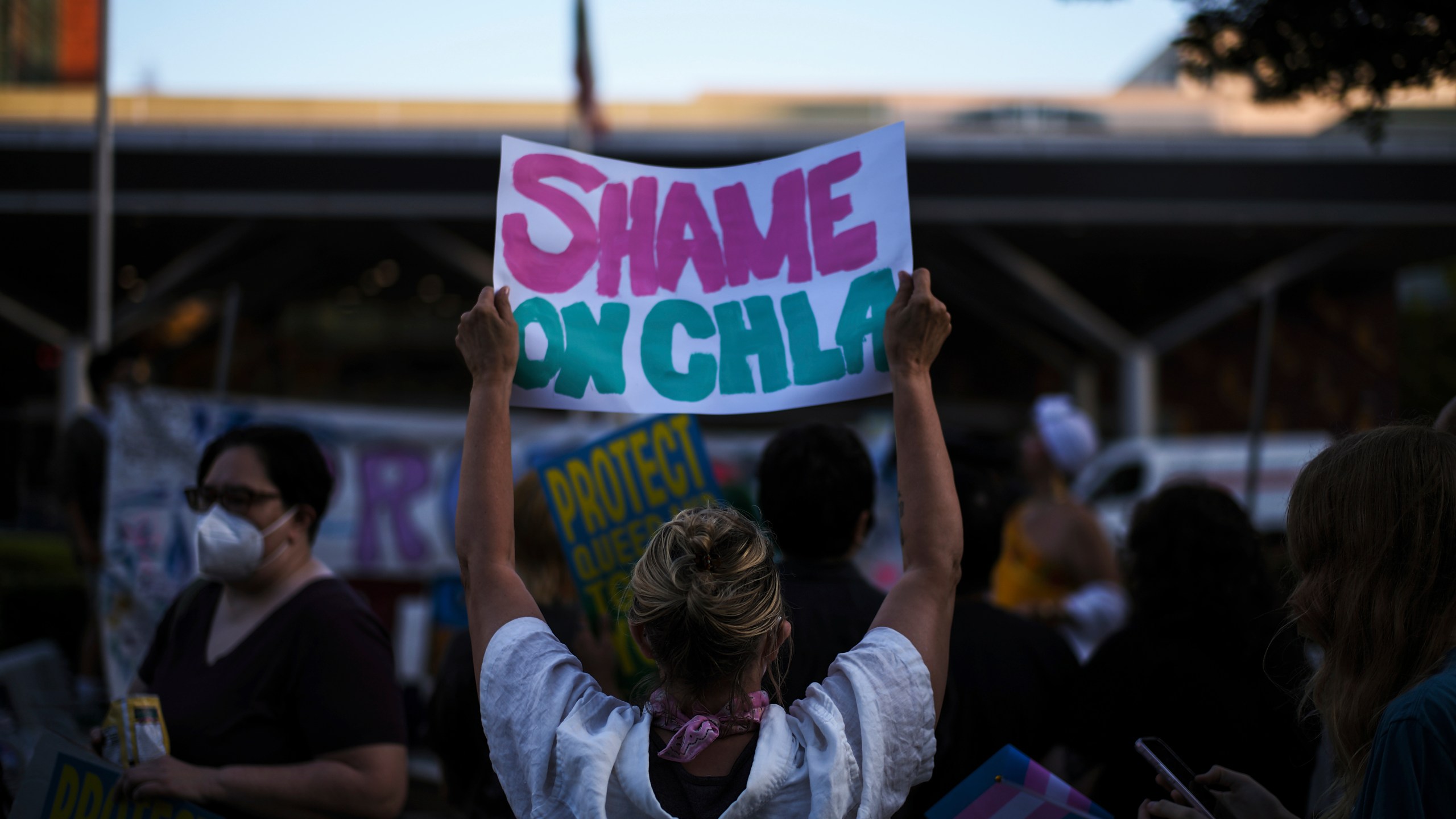 Protesters hold signs while demonstrating against the closure of the trans youth clinic at Children's Hospital Los Angeles, Thursday, July 3, 2025, in Los Angeles. (AP Photo/Jae C. Hong)