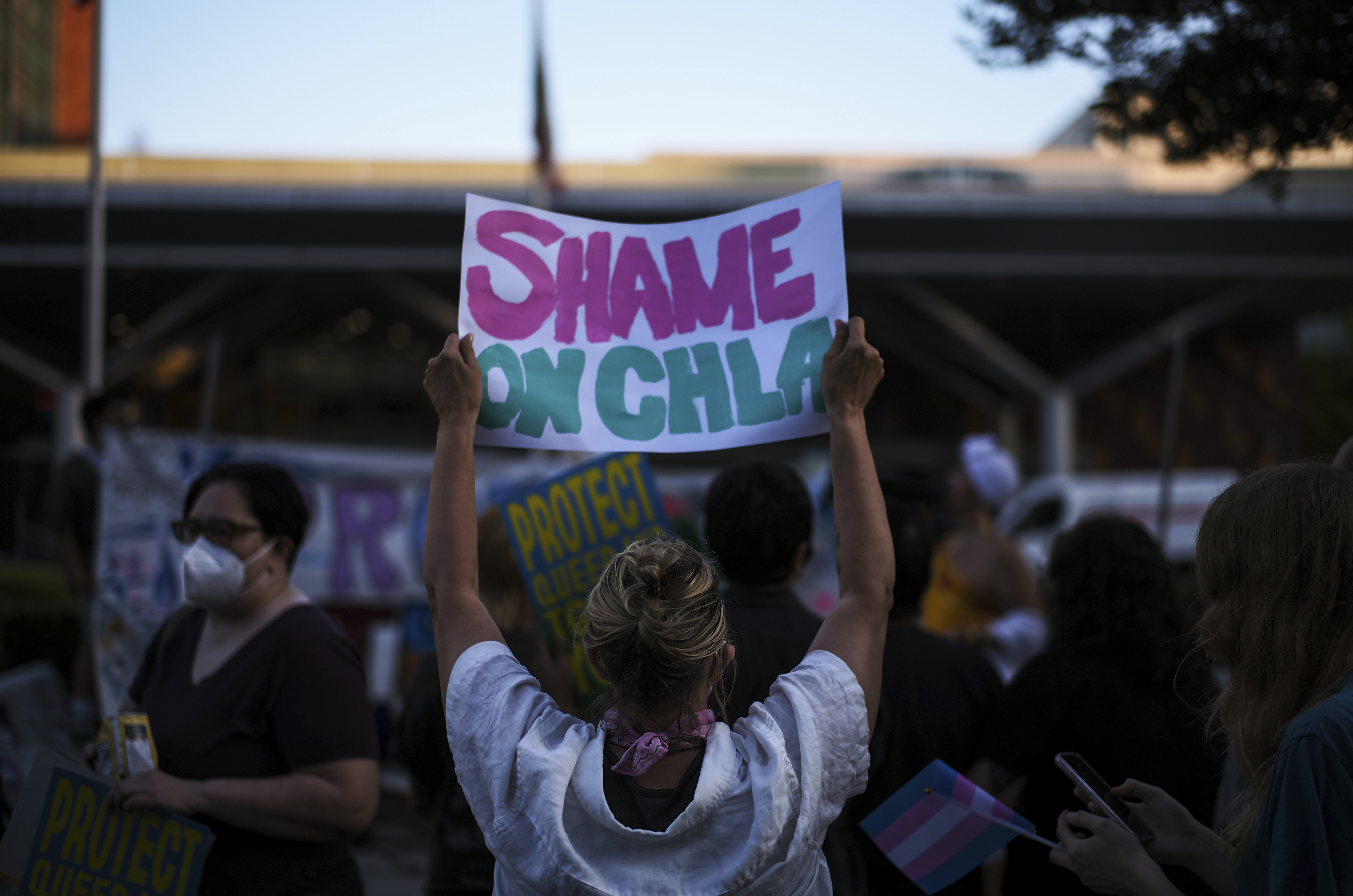 Protesters hold signs while demonstrating against the closure of the trans youth clinic at Children's Hospital Los Angeles, Thursday, July 3, 2025, in Los Angeles. (AP Photo/Jae C. Hong)