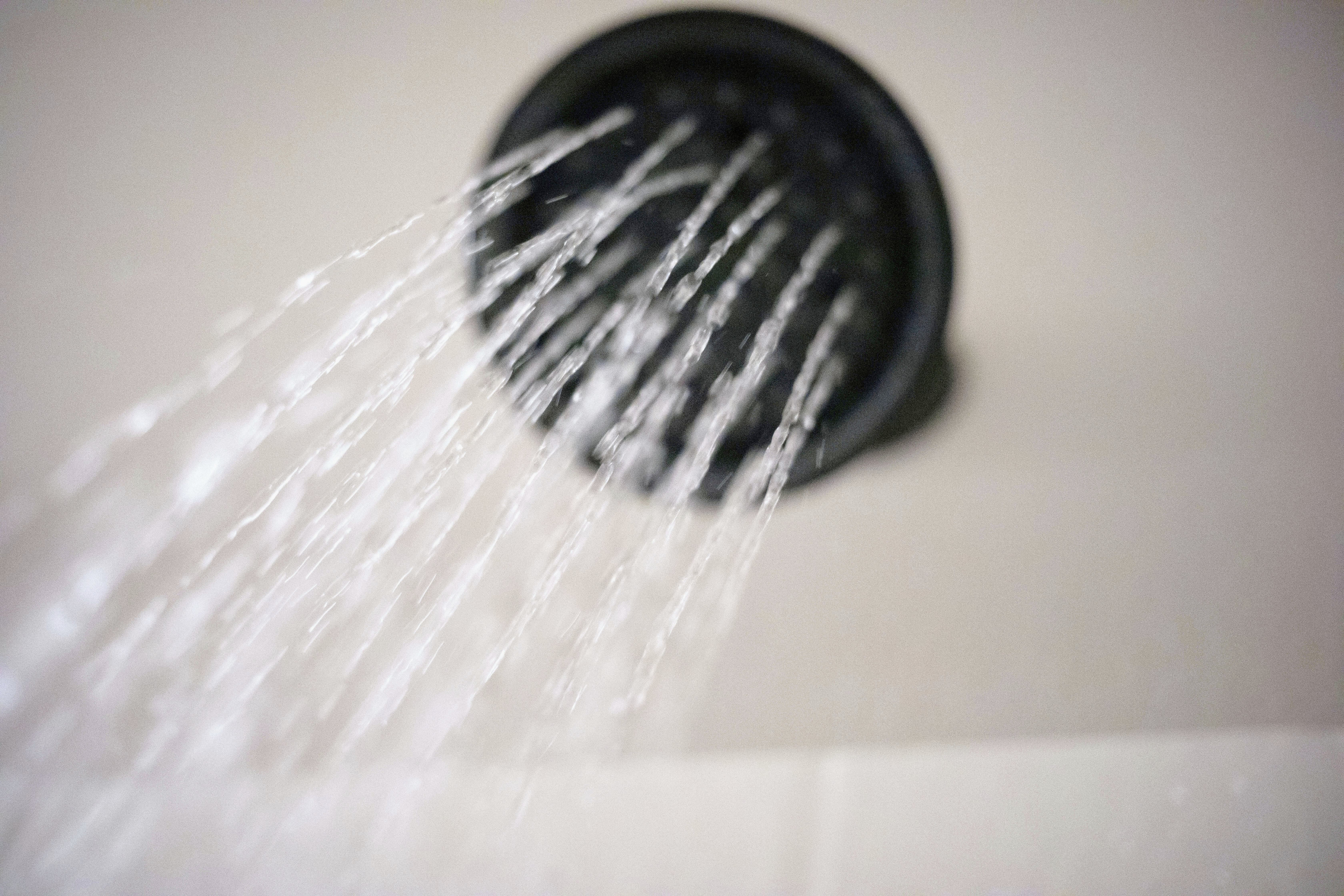 FILE - Water flows from a shower head on Wednesday, Aug. 12, 2020, in Portland, Ore. (AP Photo/Jenny Kane, File)