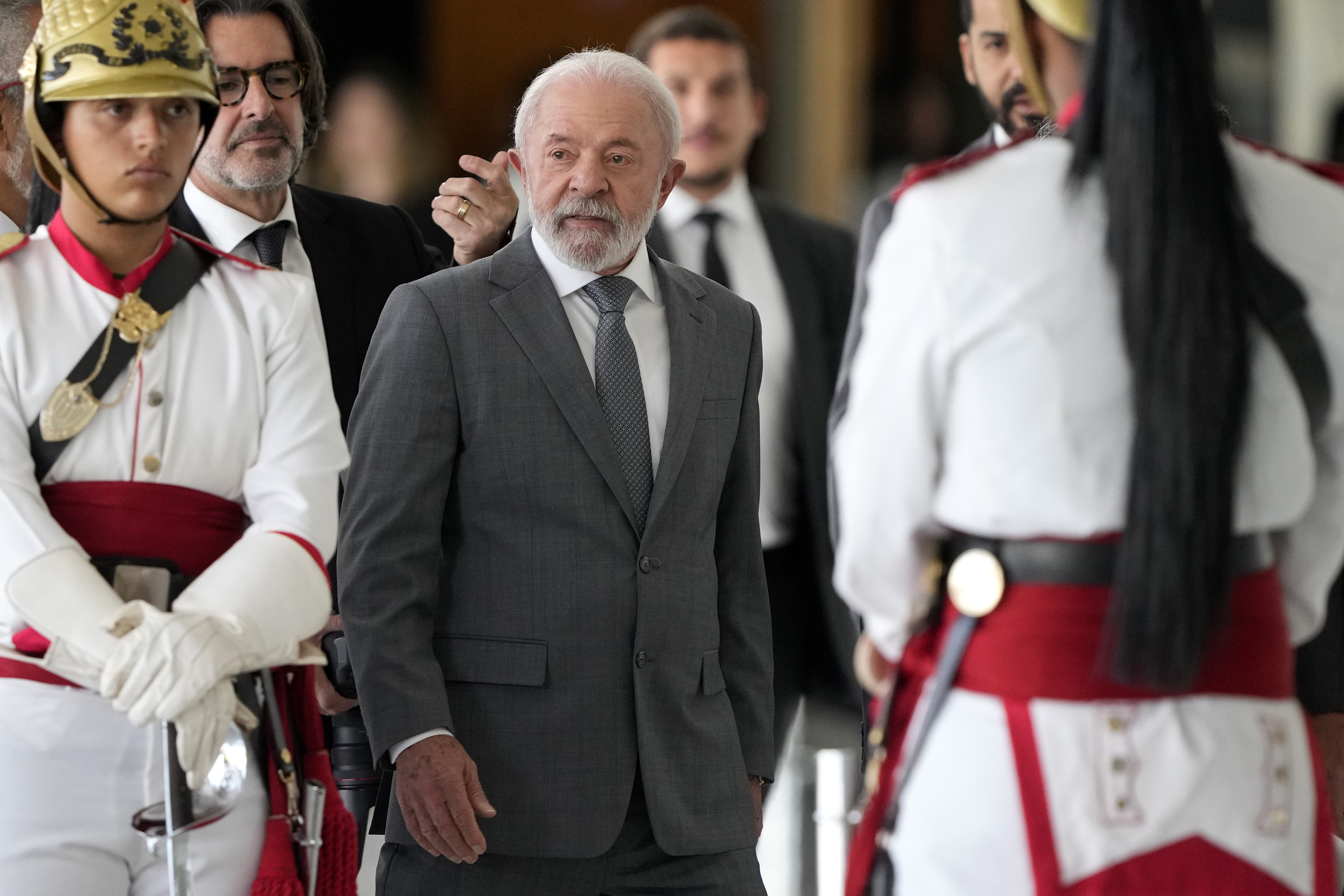 Brazil's President Luiz Inacio Lula da Silva walks among presidential guards during an event at the Planalto presidential palace in Brasilia, Brazil, Wednesday, July 9, 2025. (AP Photo/Eraldo Peres)