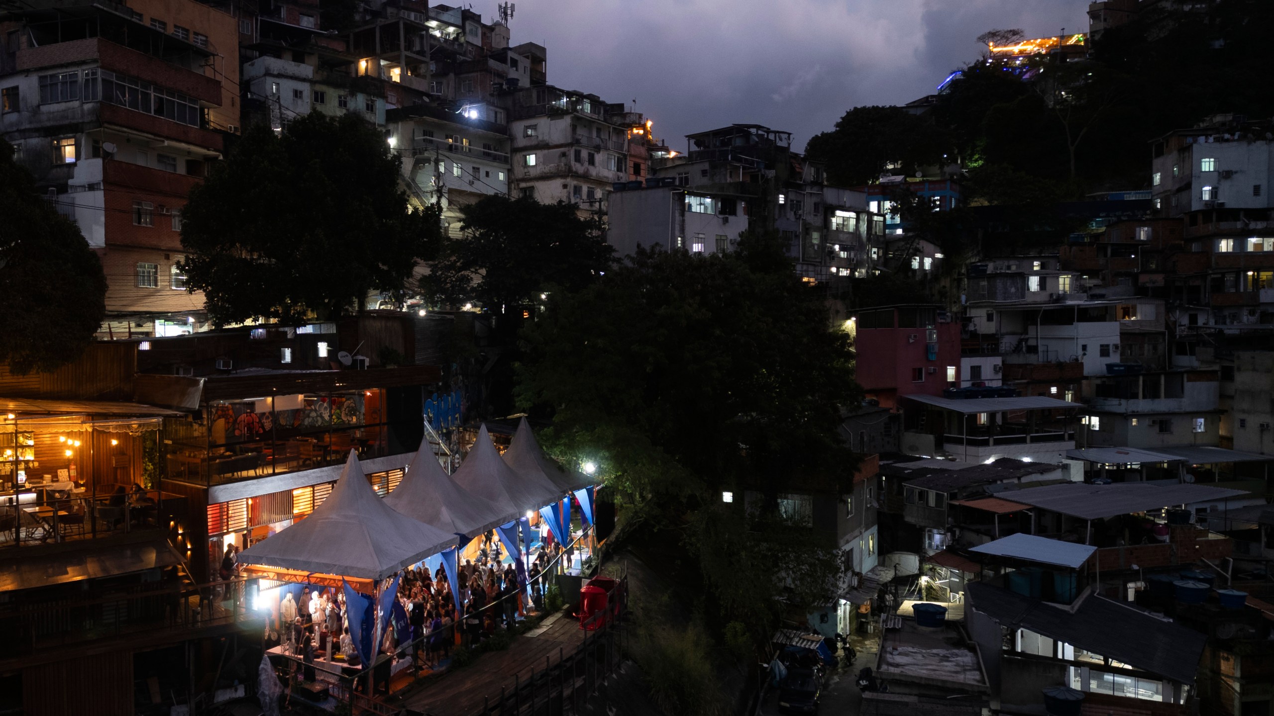 People attend a performance by American vocalist of Hindu devotional music Jeff Kagel during a Tranformation Project yoga class in the Rocinha favela, Rio de Janeiro, Wednesday, July 9, 2025. (AP Photo/Bruna Prado)