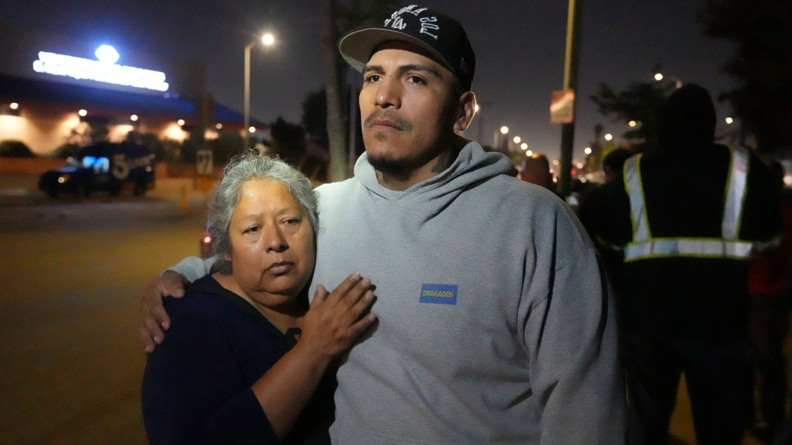Maria Orozco hugs her son, Oraldo Orozco, one of her three sons who were trapped as tunnel workers inside a collapsed tunnel under construction for Los Angeles County's Clean Water project, Wednesday, July 9, 2025, in Los Angeles. (AP Photo/Damian Dovarganes)