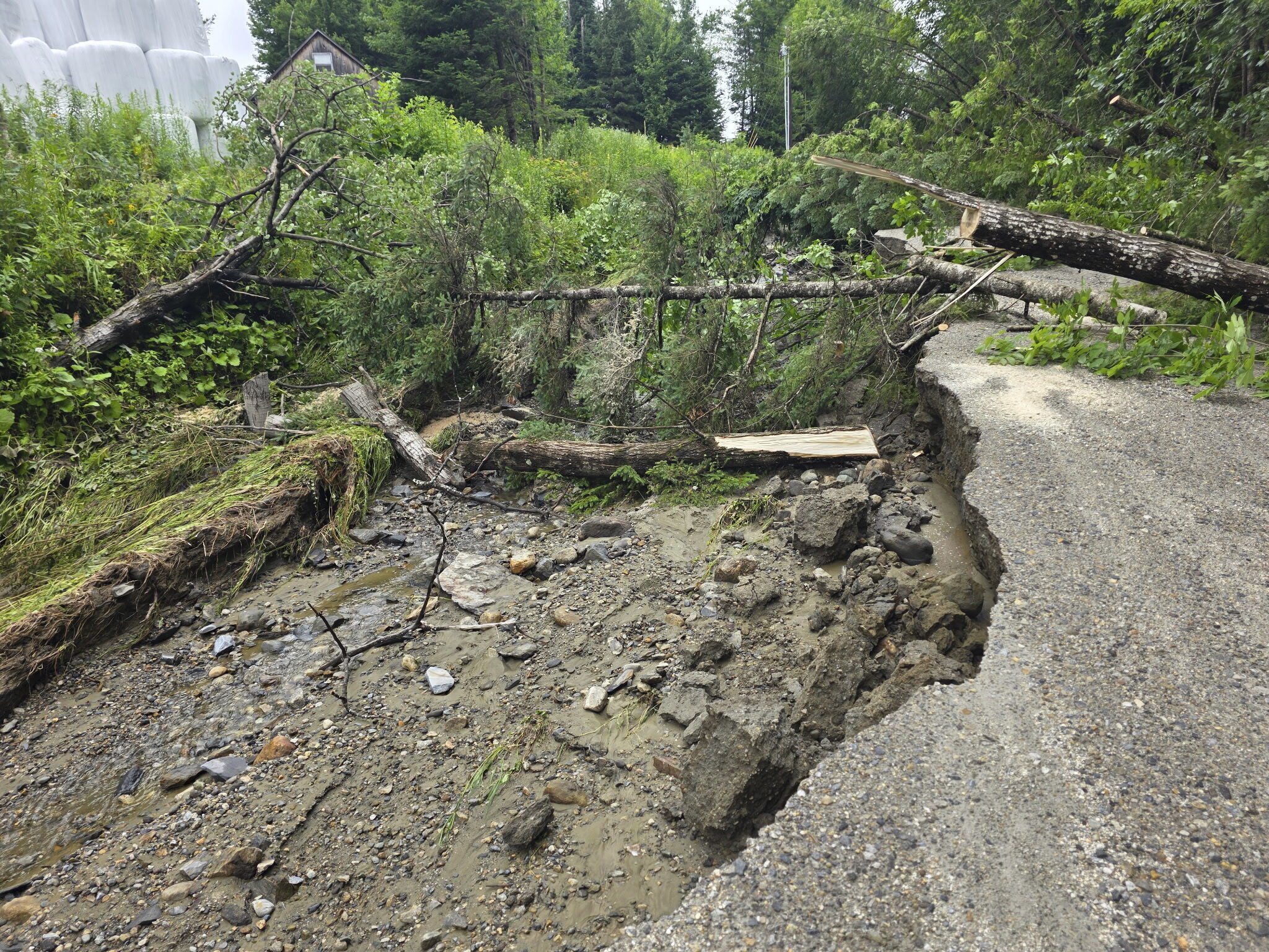 This handout photo provided by Sutton Fire Chief Kyle Seymour, shows roads and homes damaged on Thursday, July 10, 2025 due to flash flooding caused by heavy rains in Sutton, Vt. (Sutton Fire Chief Kyle Seymour via AP)