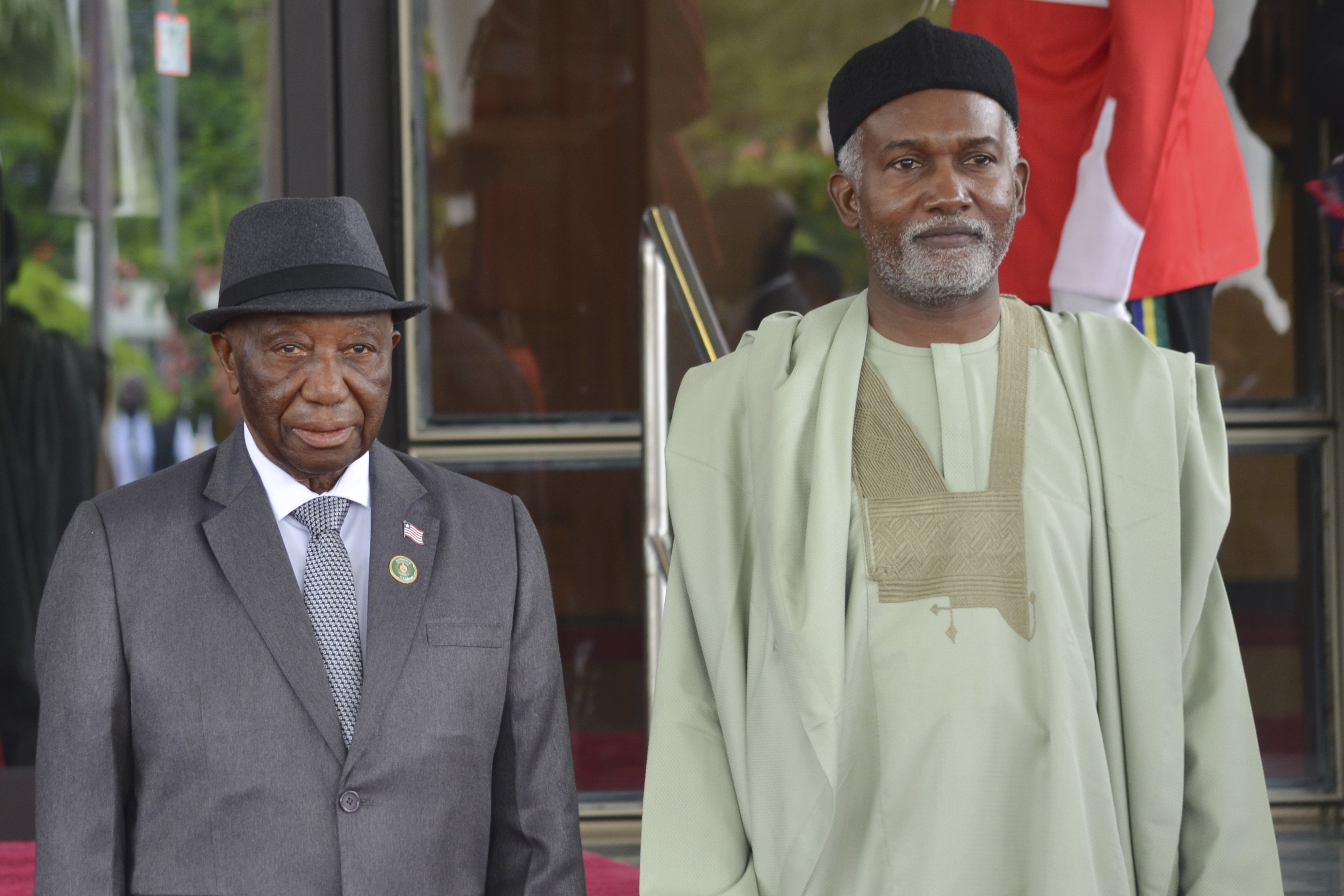 FILE - Liberia's President, Joseph Boakai, left, and Nigeria Minister of Foreign Affairs, Yusuf Tuggar, right, pose for a photo, prior to the start of the ECOWAS meeting, in Abuja, Nigeria, July 7, 2024. (AP Photo/Olamikan Gbemiga, File)